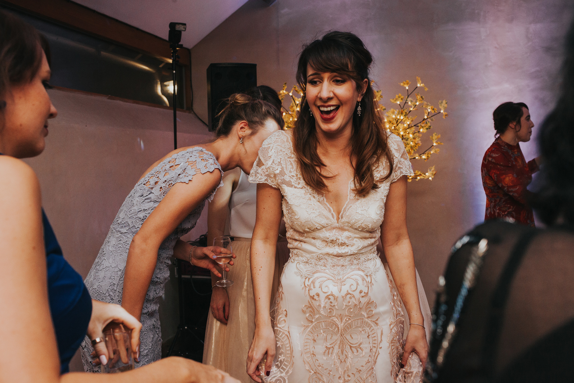 Bride laughing on dance floor. 