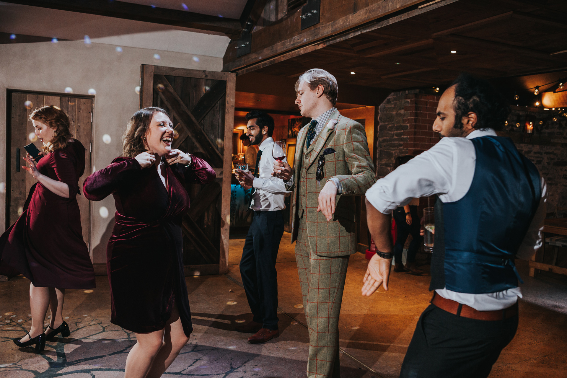 Guests laughing on dance floor. 