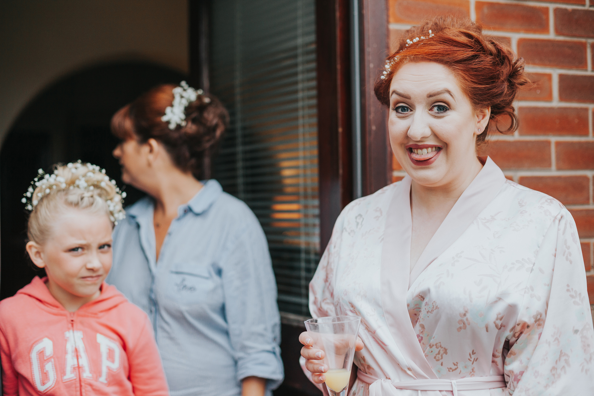 Bride looking excited, flower girl in background looking unsure.