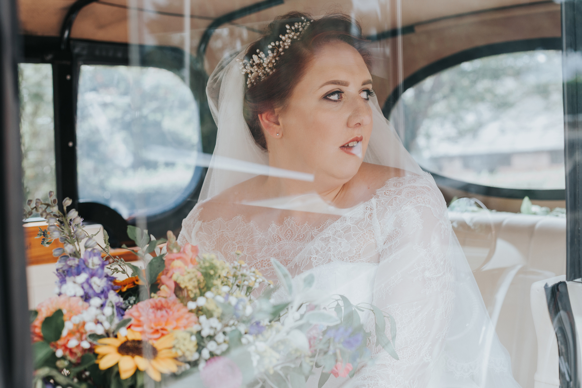 Bride in wedding car though the window. 