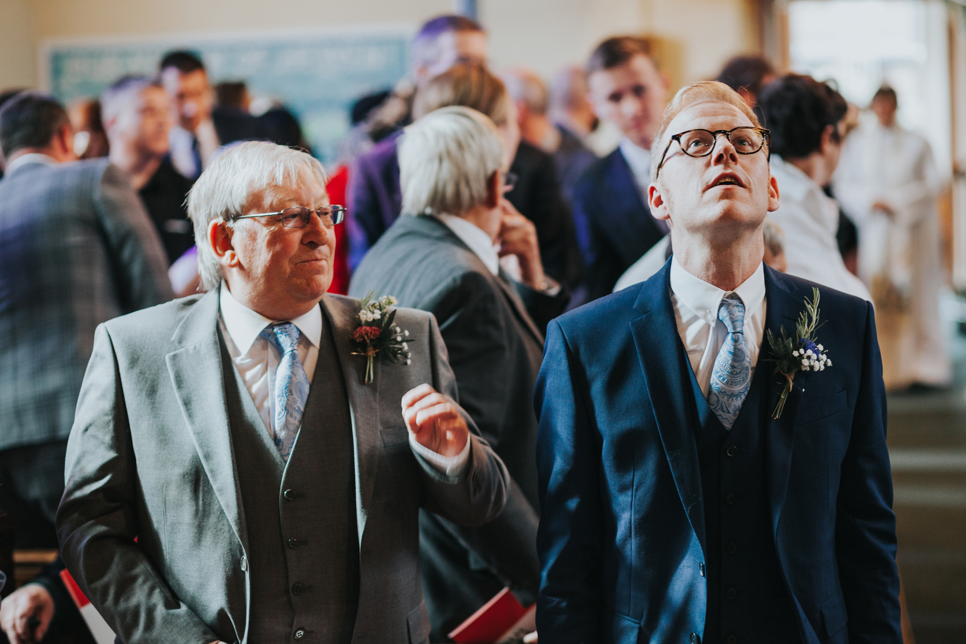 Groom looking up as he waits for the bride to arrive.