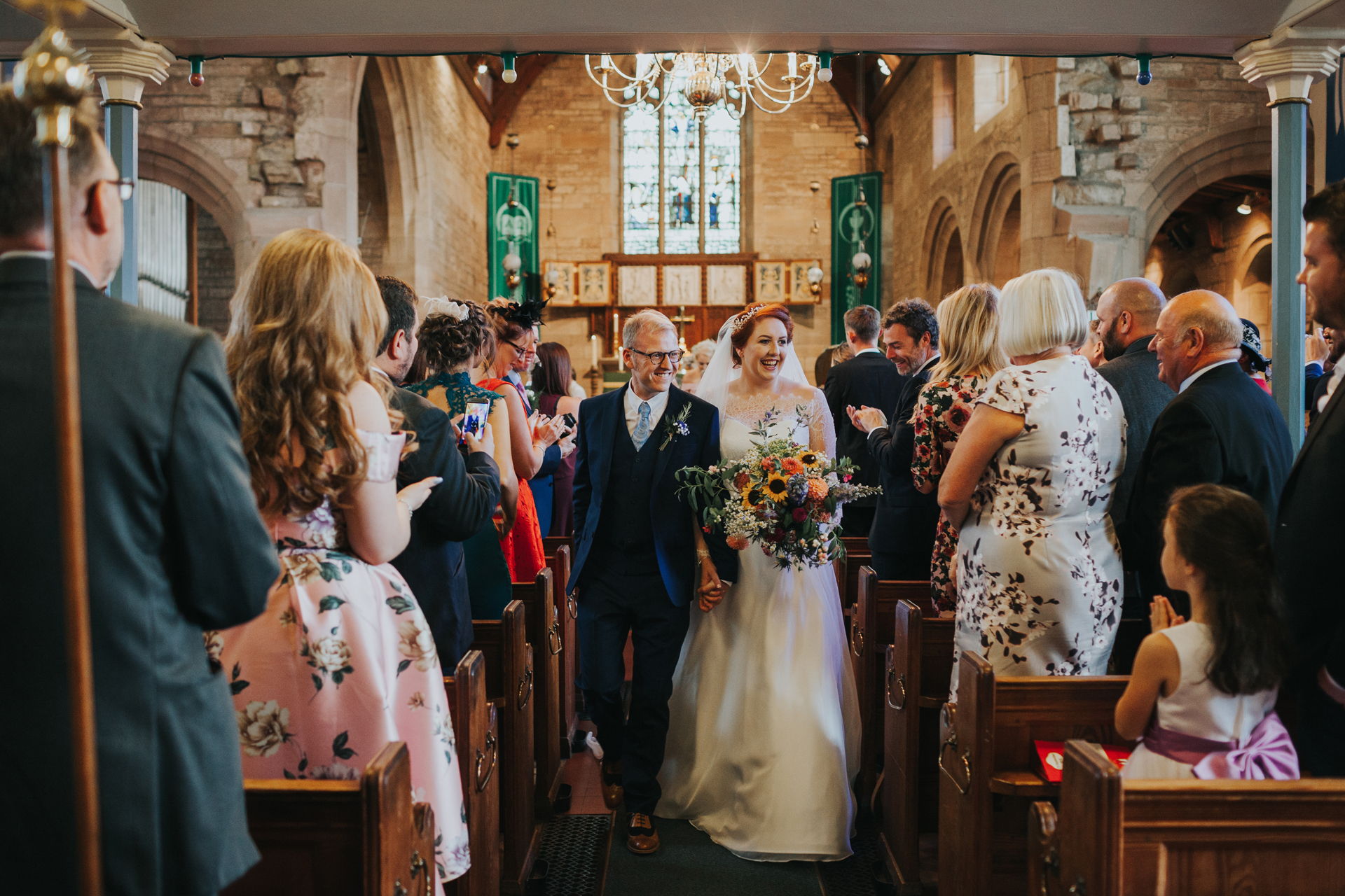 Bride and groom make their way down the aisle as man and wife. 