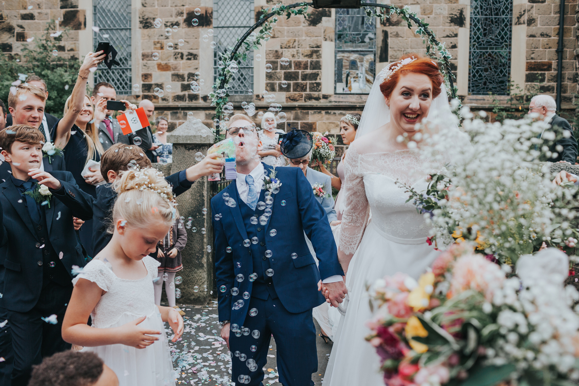 Groom blows bubbles. 