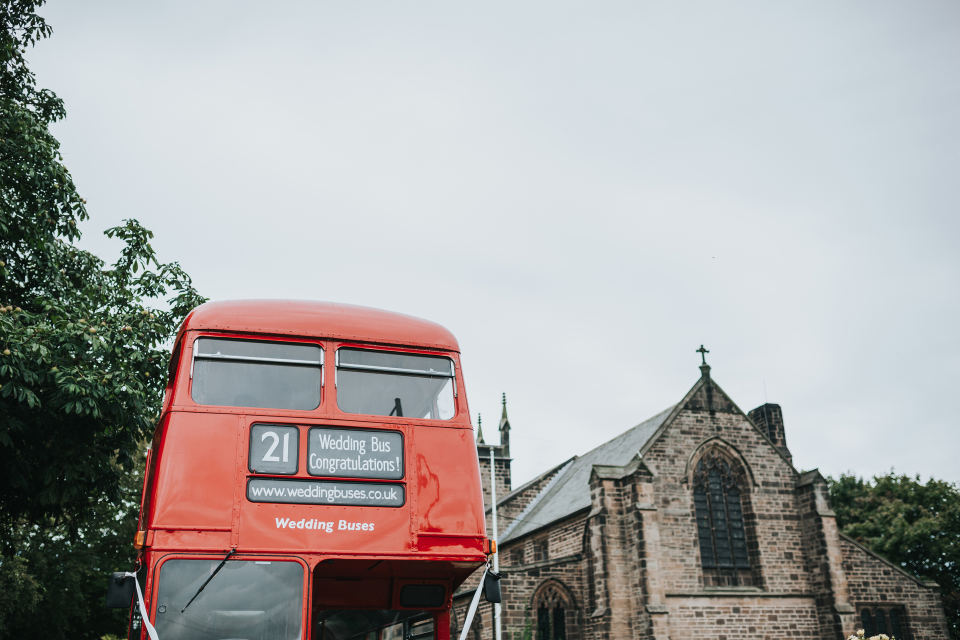 Front of the wedding bus parked next to the church. 