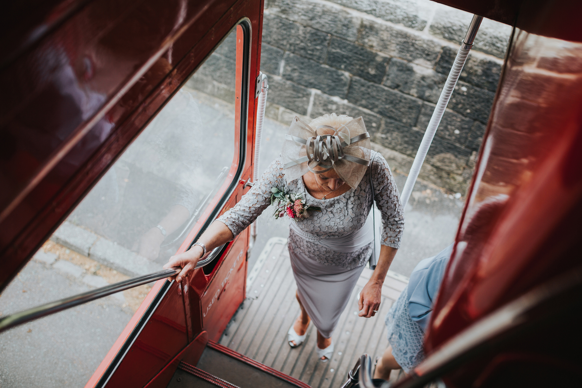 Mother of the bride steps onto the wedding bus. 