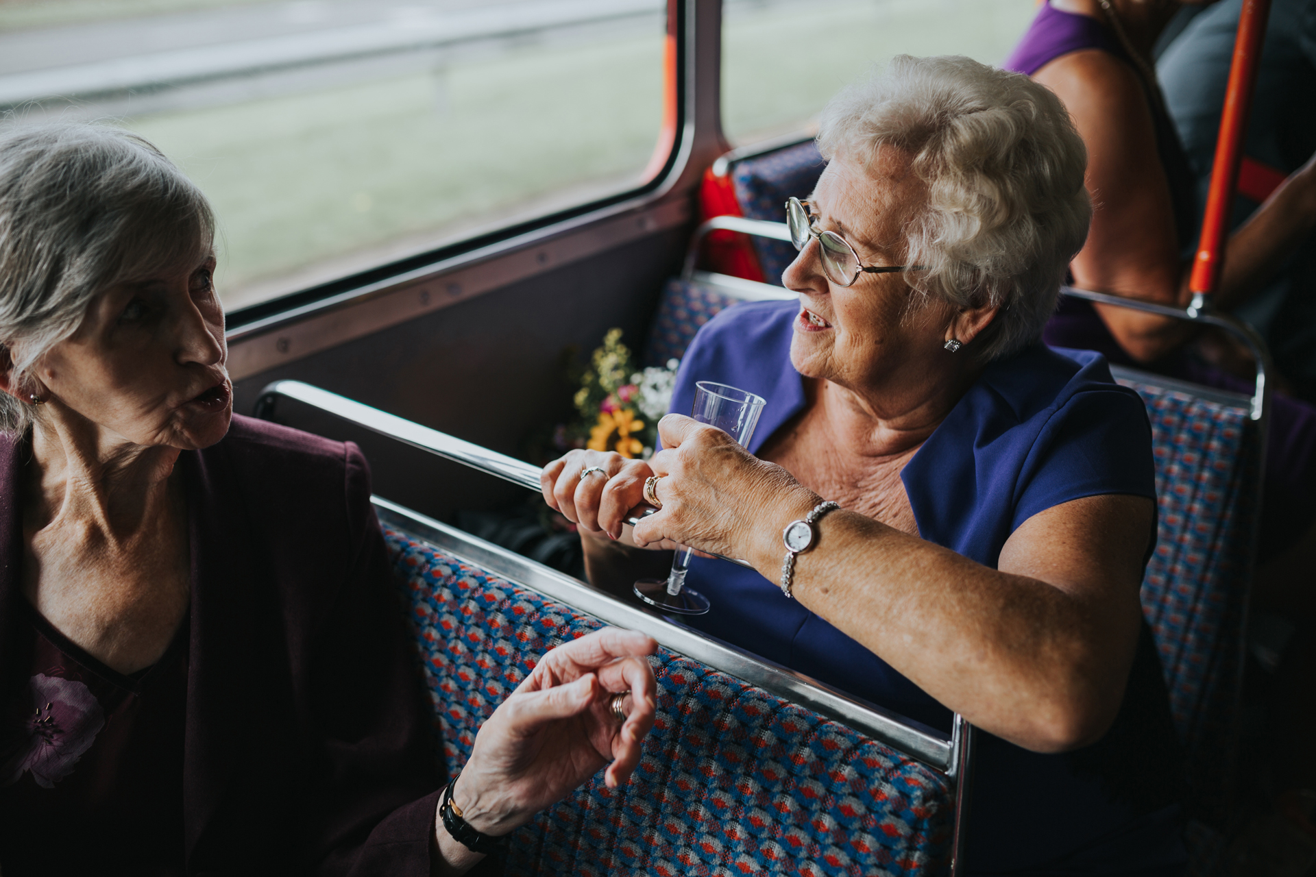 Guests chat on the wedding bus. 