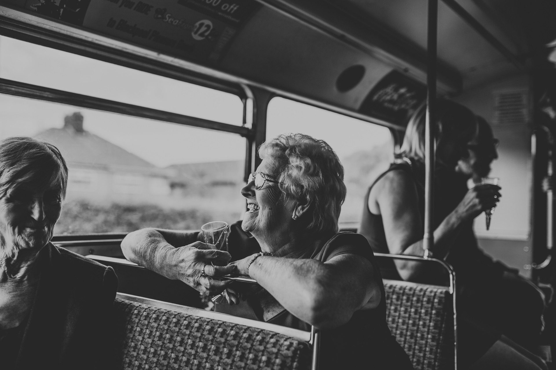 Lady looks on of the bus window.