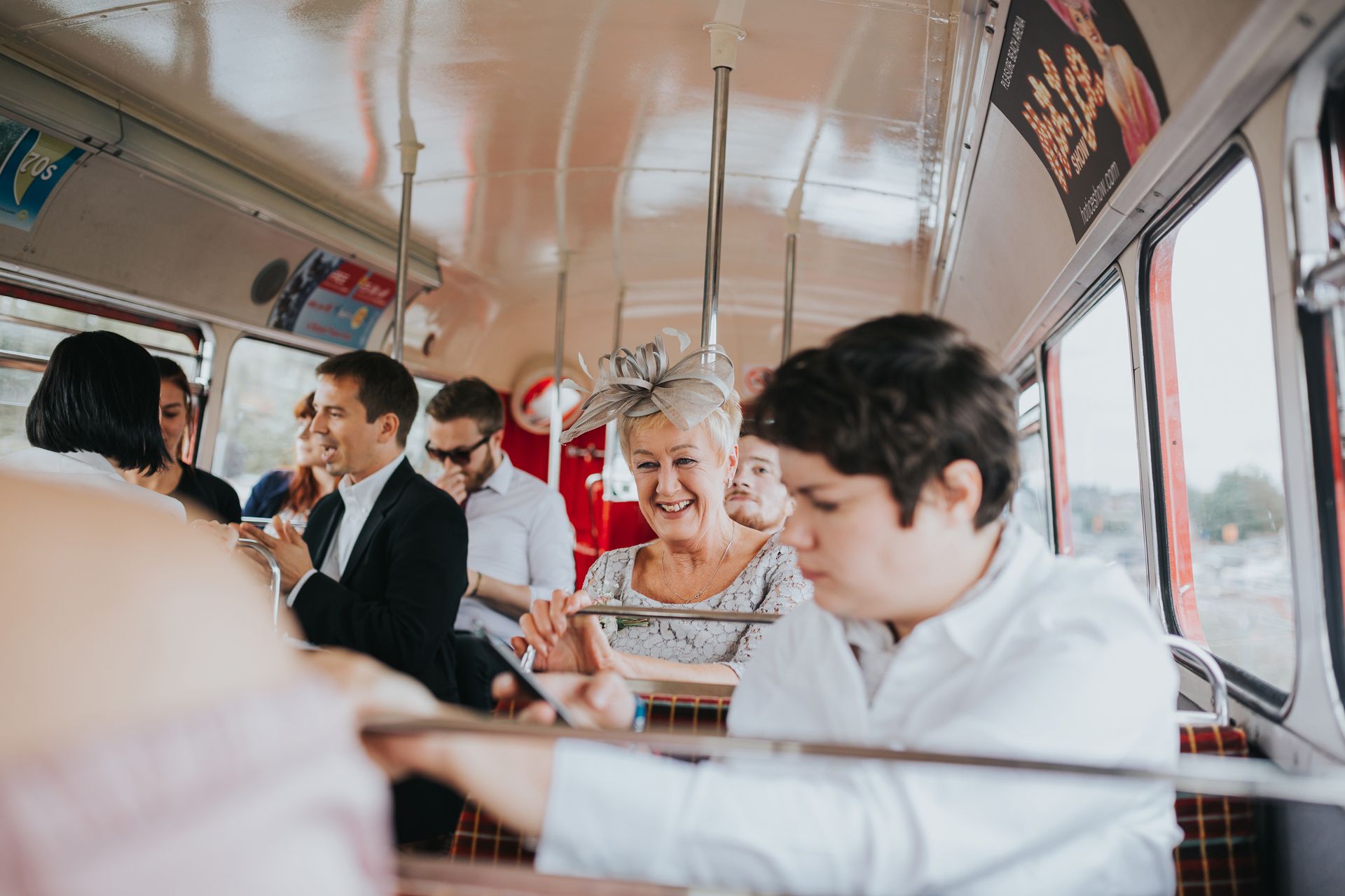 Mother of the bride on the wedding bus laughing. 