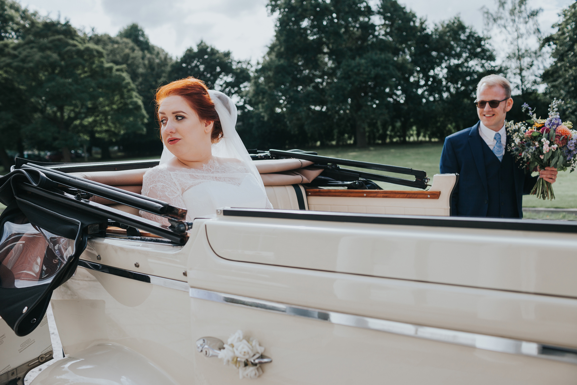 Bride and groom arrive at Trafford hall in their wedding car.