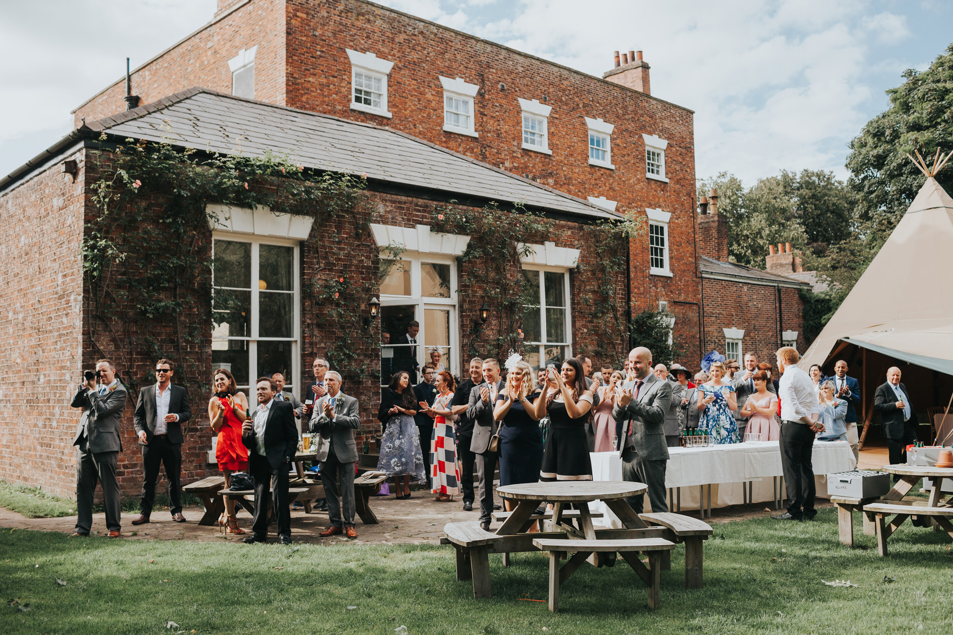 Wedding guests enjoy the garden at Trafford hall. 