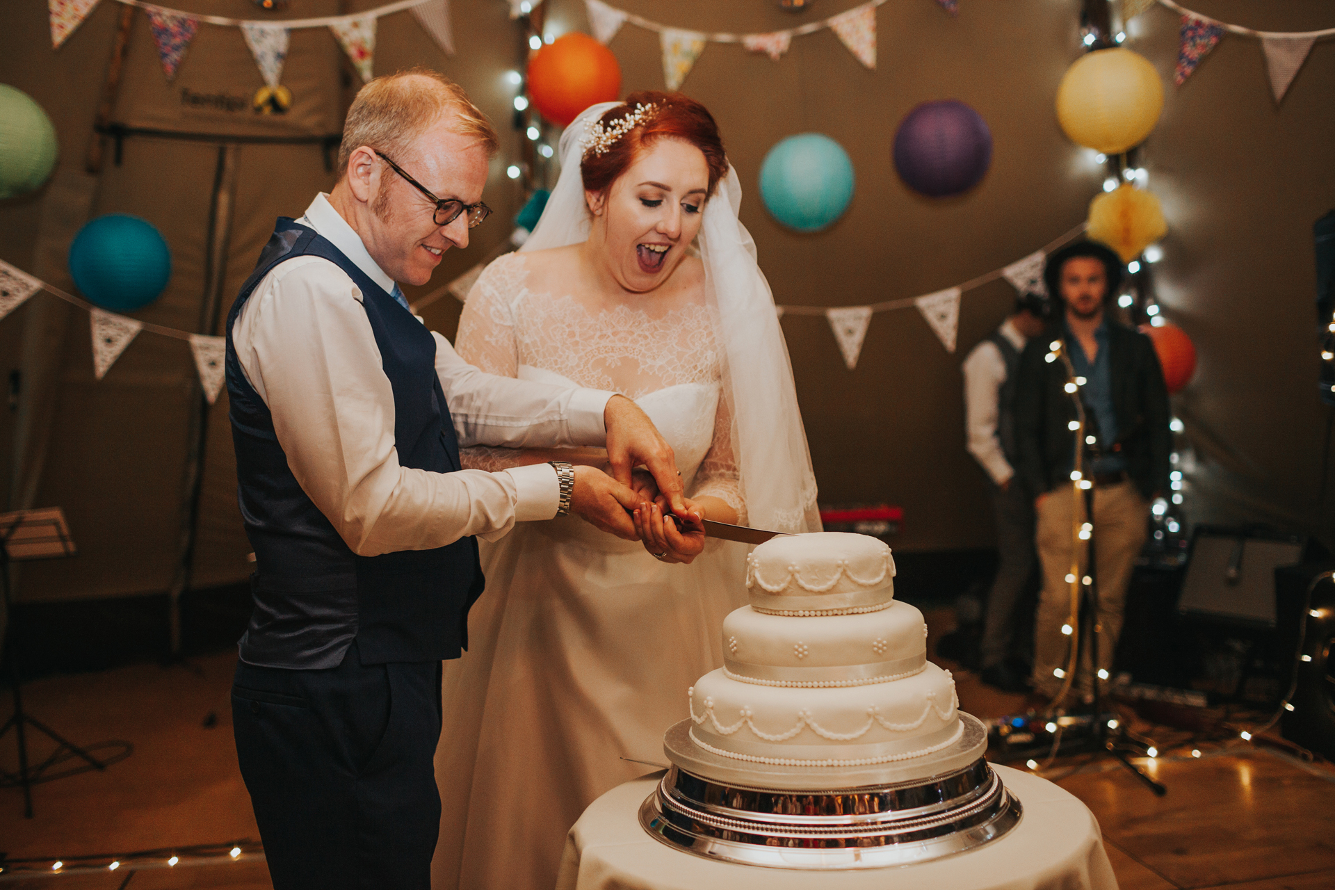 Bride and groom cut cake. 
