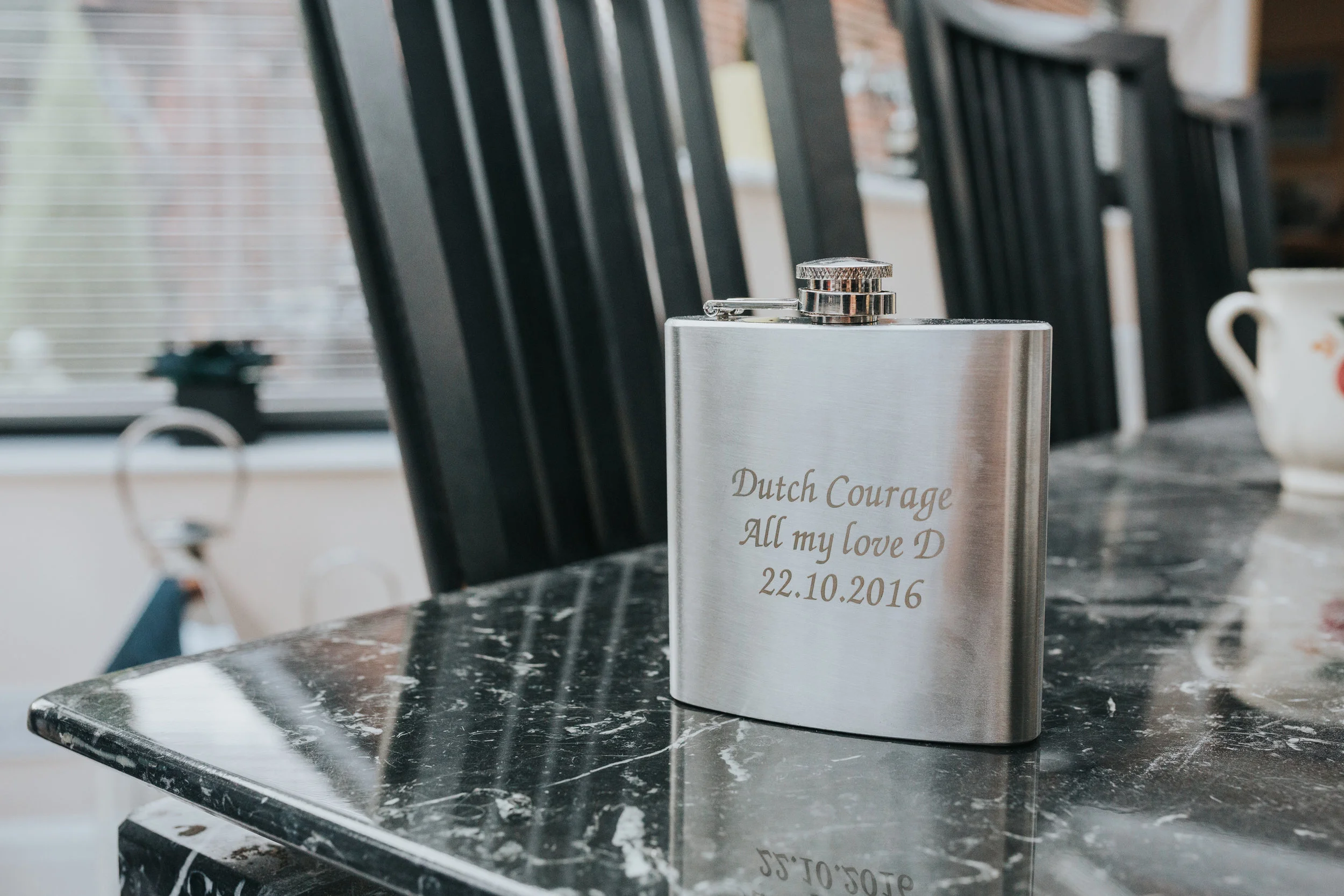 An engraved hip flask, a wedding morning gift from the bride to the groom. 