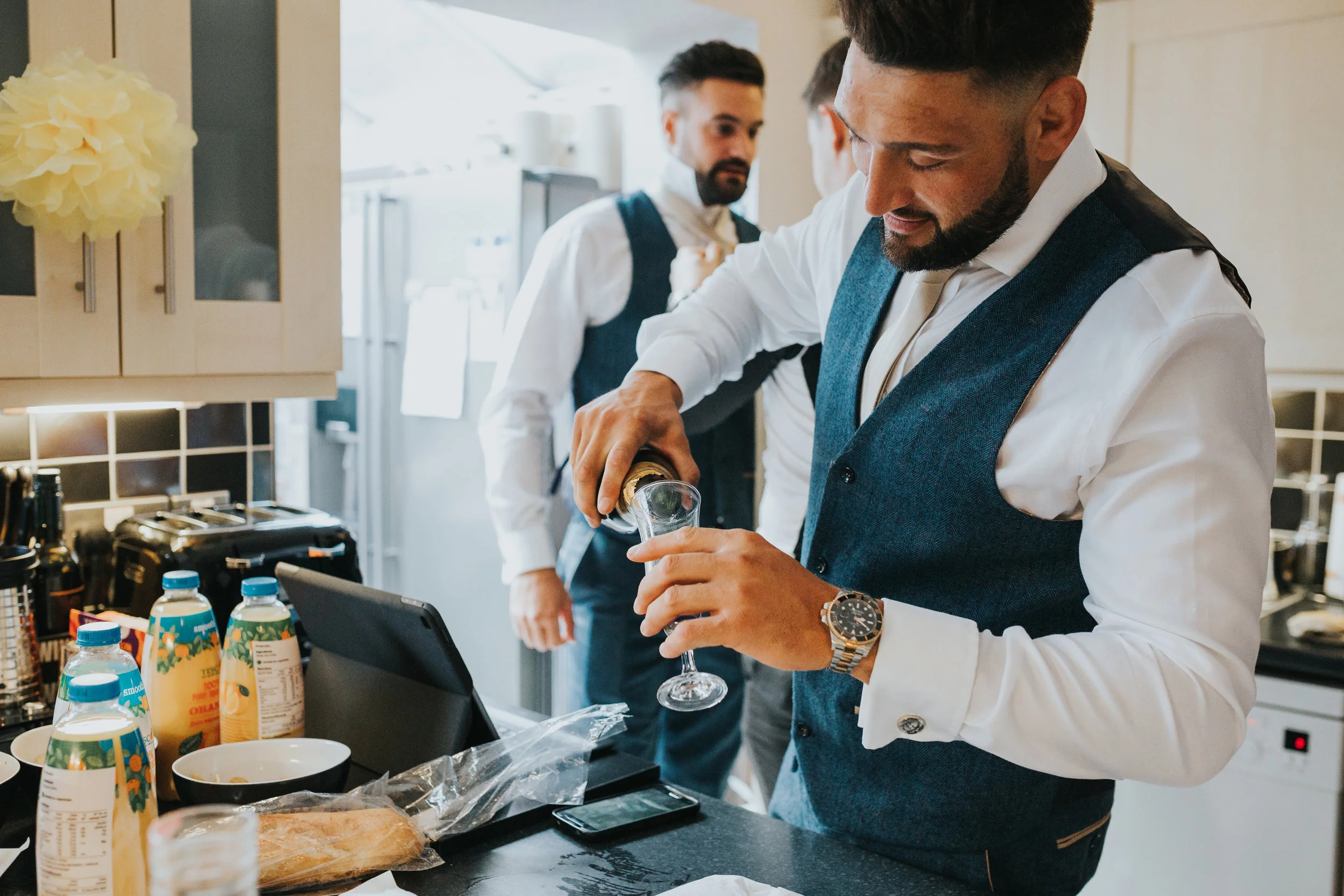 Groomsman pouring a drink. 