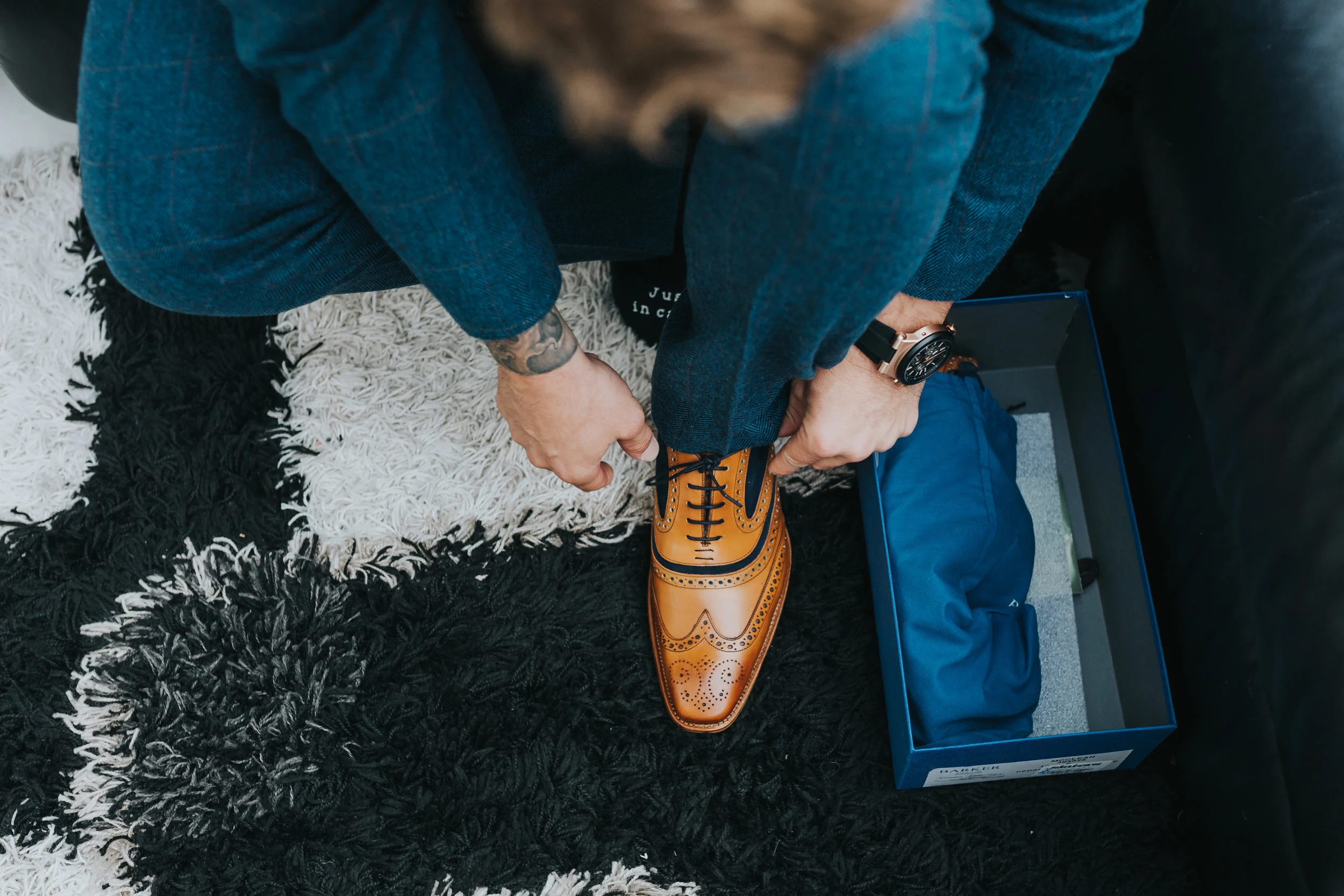 Groom putting on shoes. 