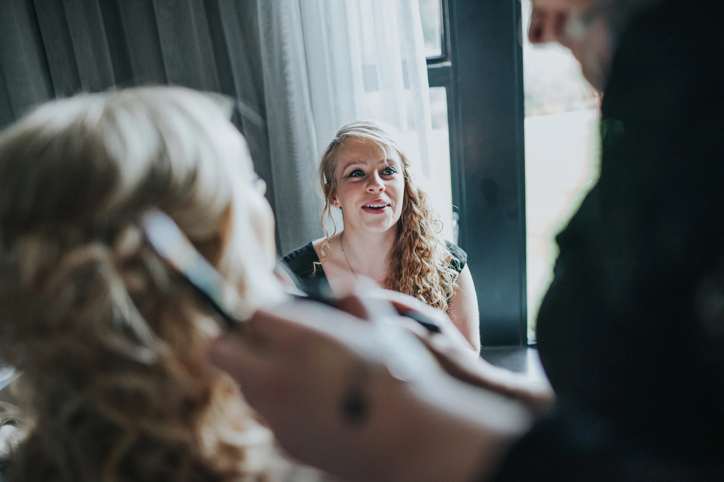Friend looks on as the girls get ready. 