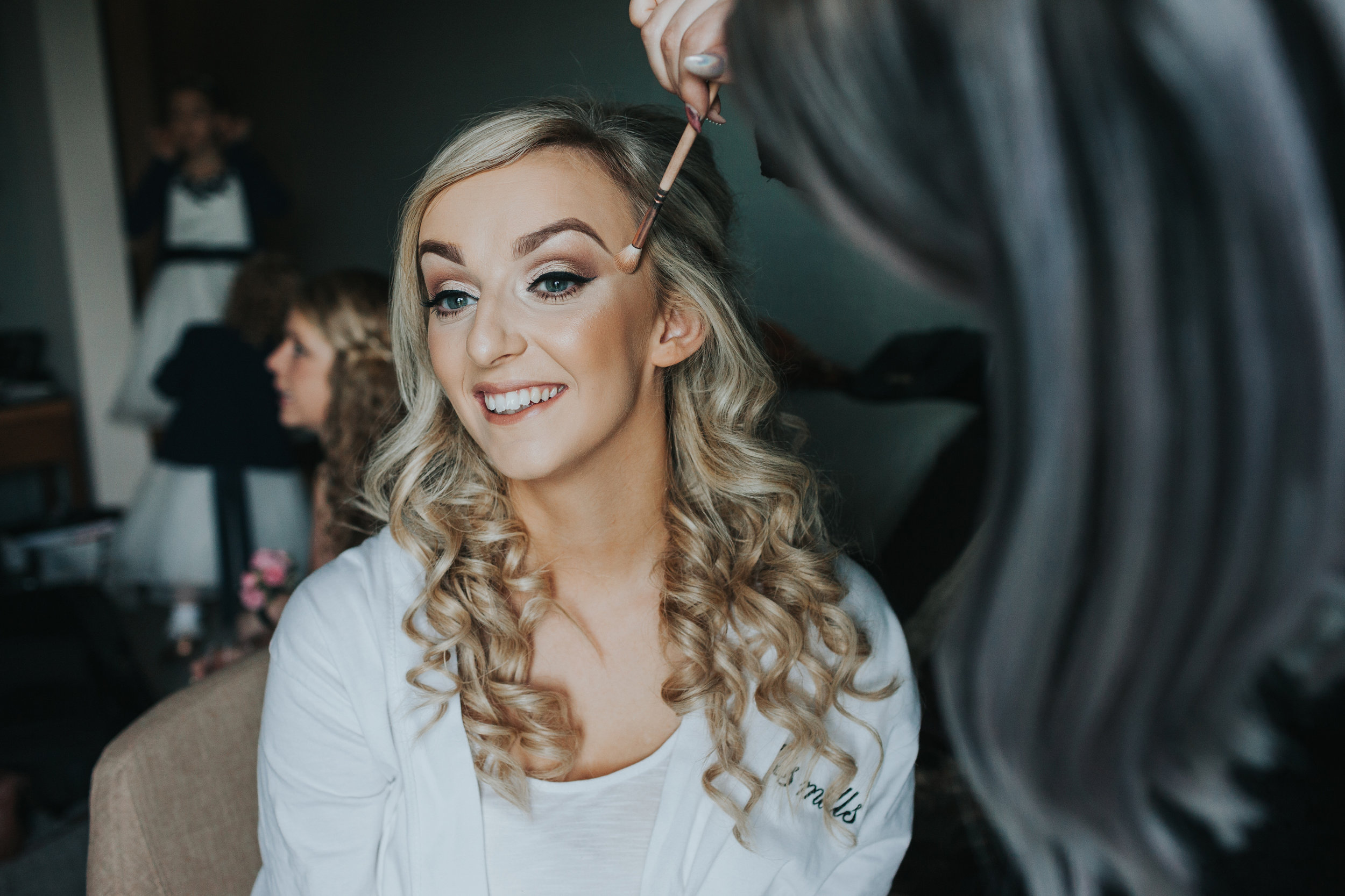 Bride getting her make up put on. 