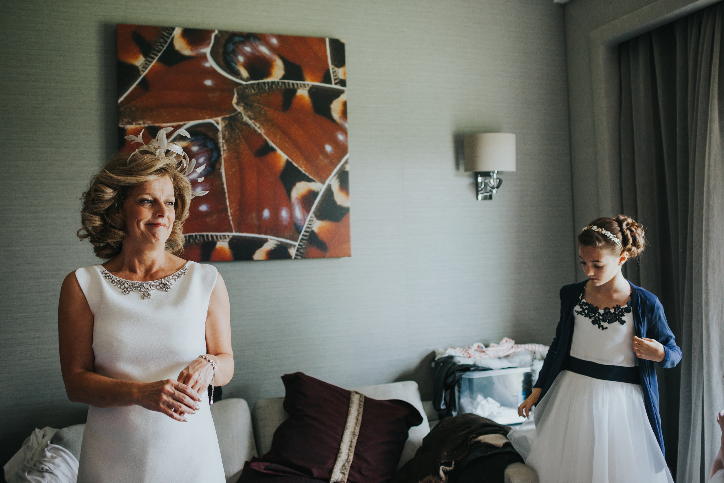 Mother of the bride watches her daughter getting ready.