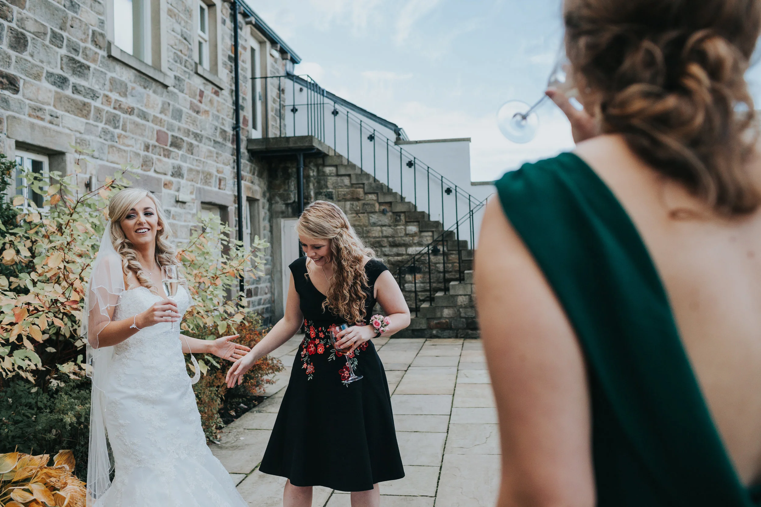 The bride laughs with friends. 