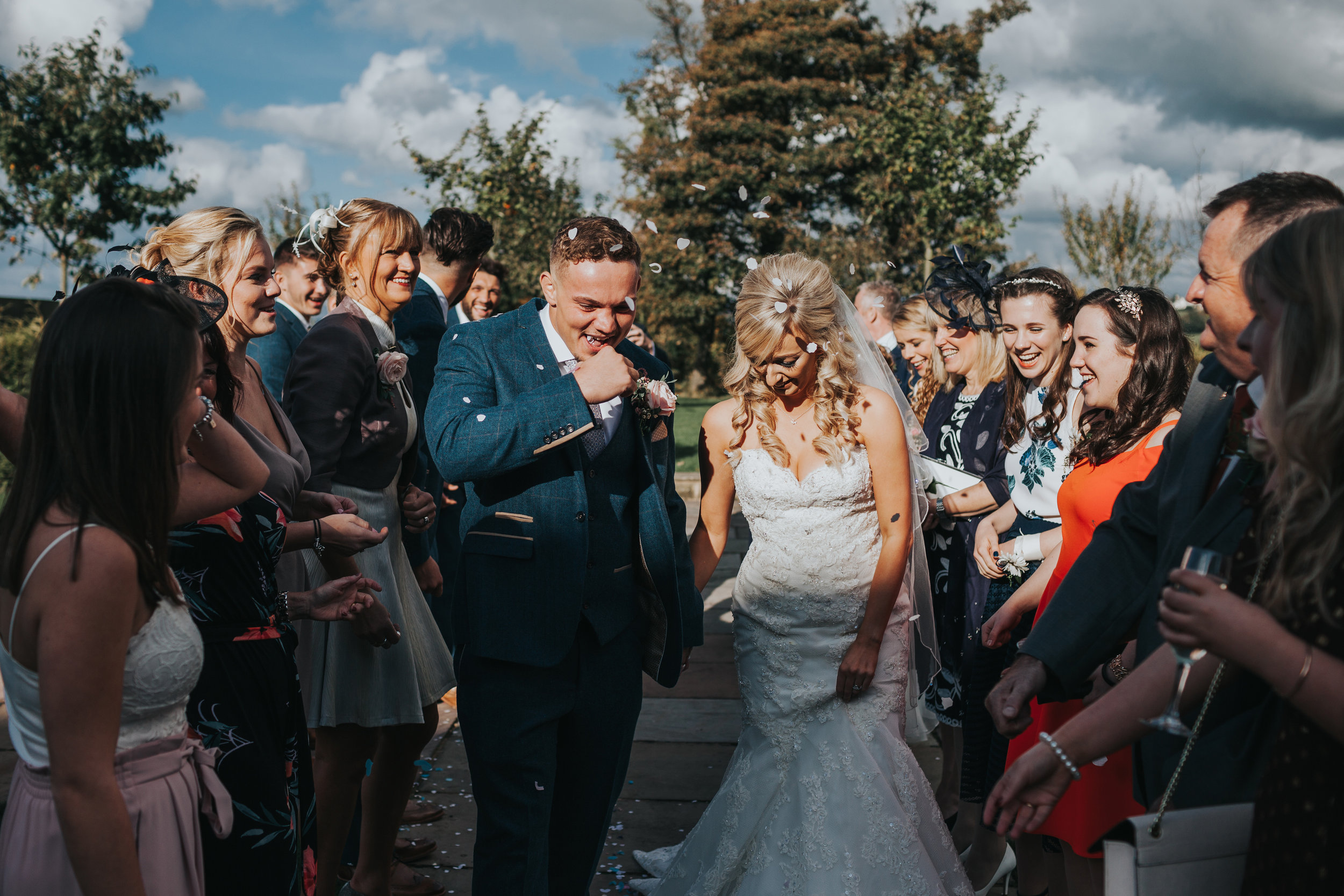 Groom gets confetti in his mouth.