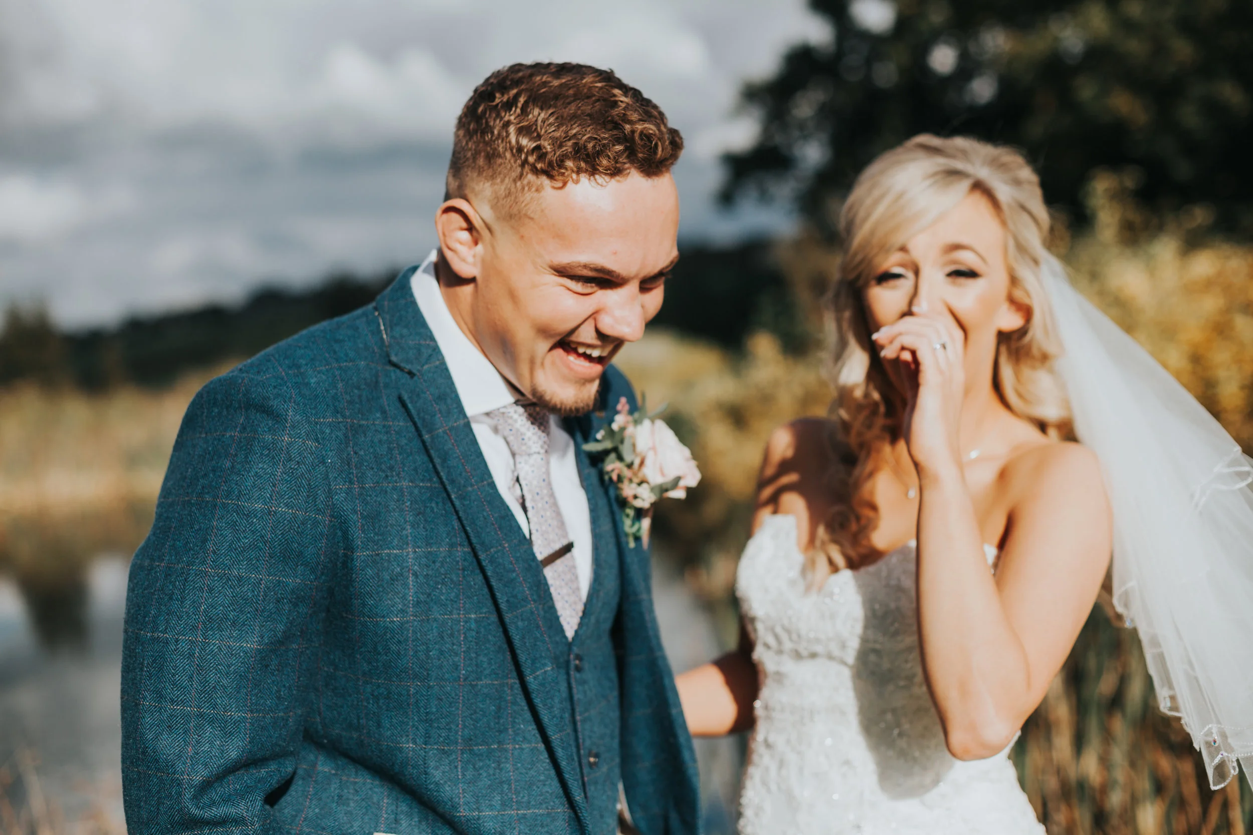 Bride and Groom laugh together. 