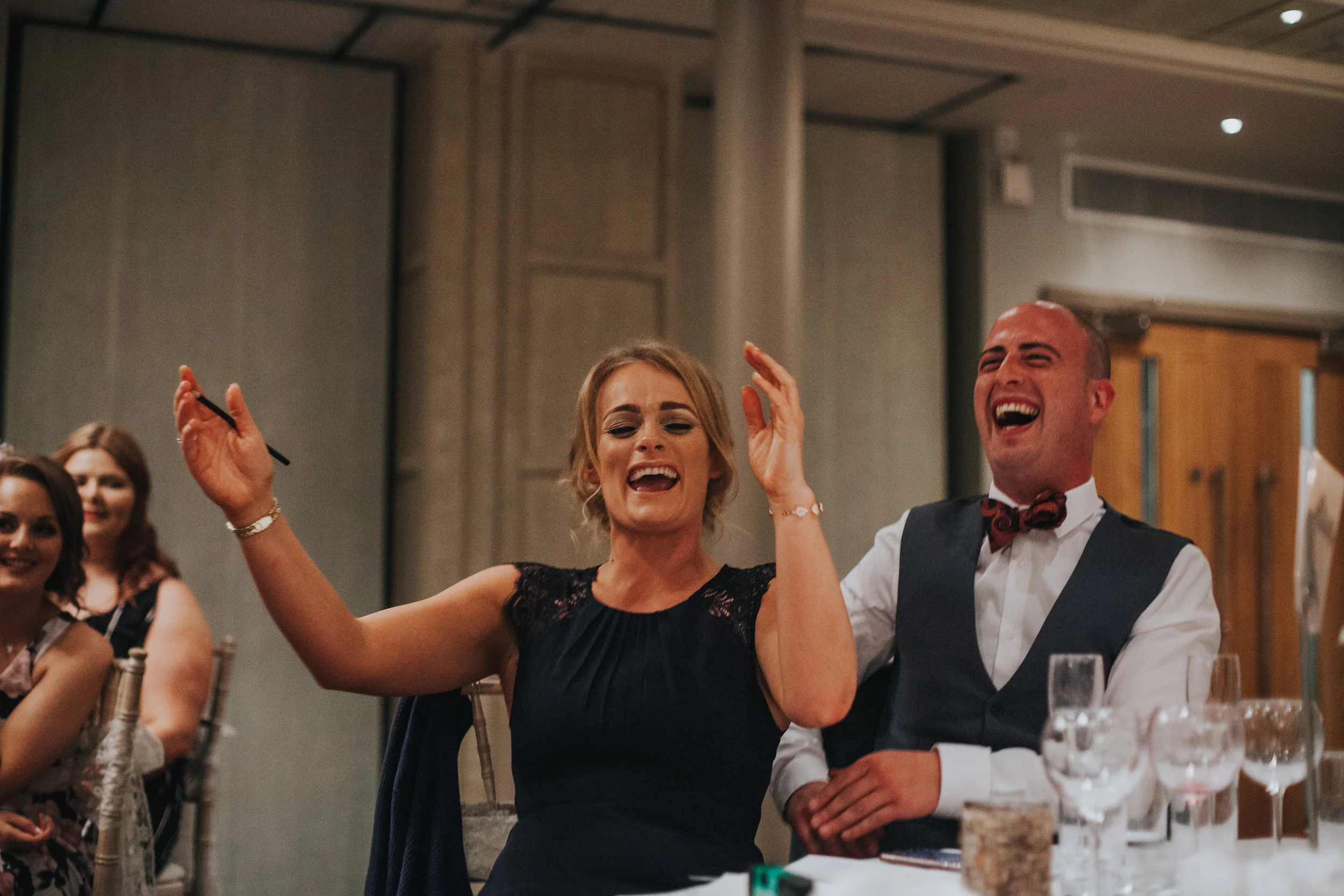 Couple howling with laughter.