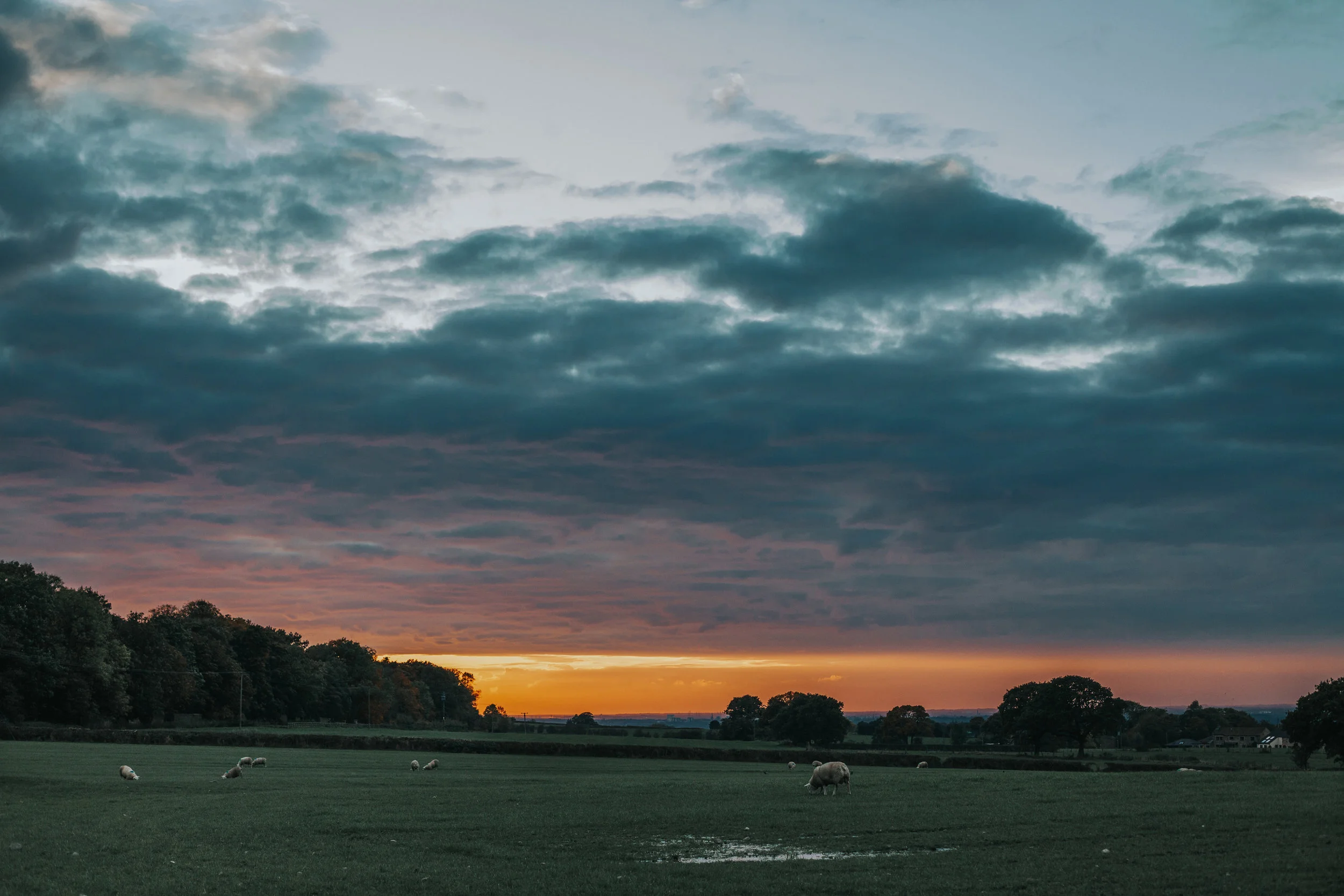 The sun sets over the hills. 