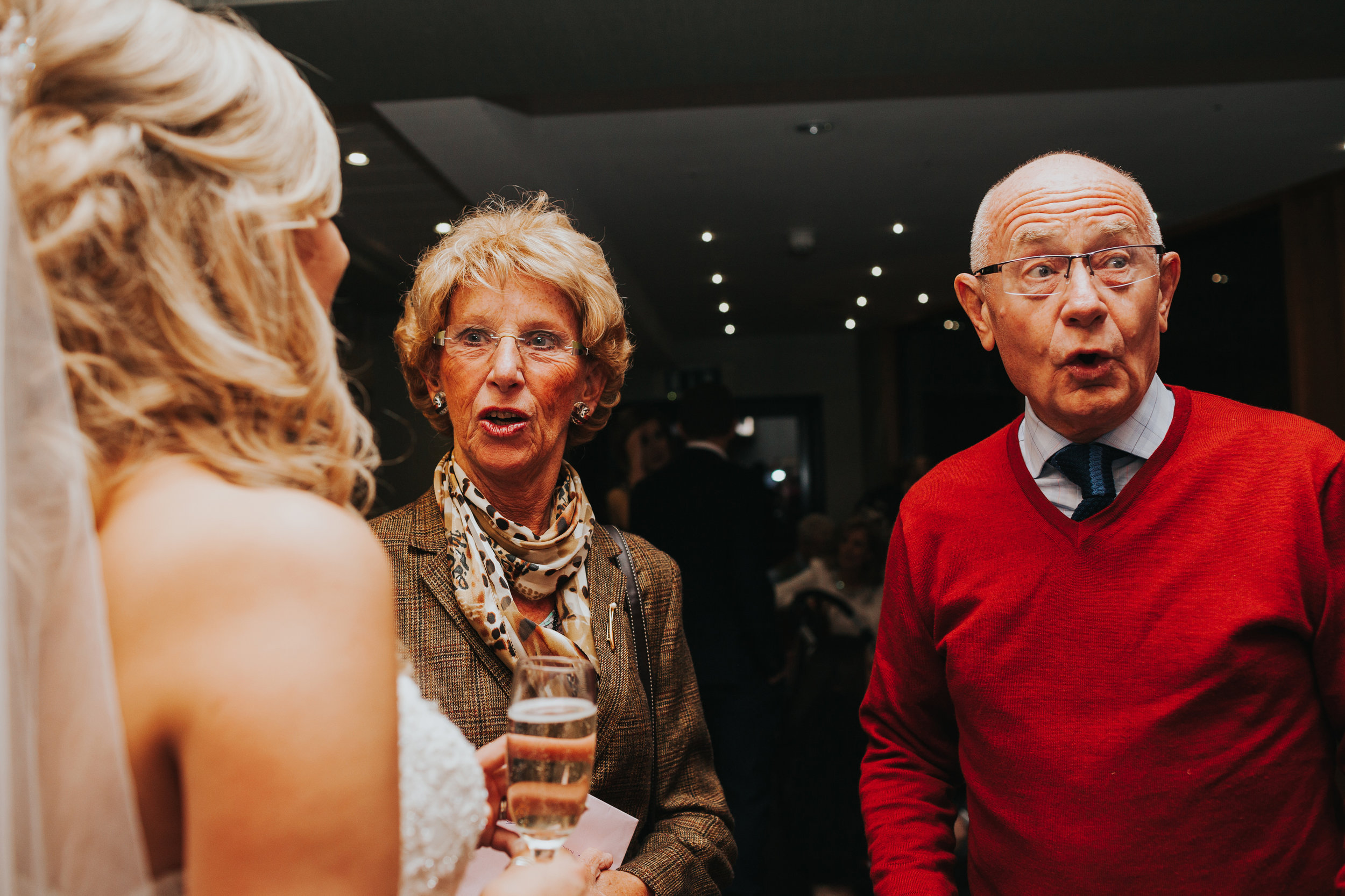 Wedding guests pulling funny faces.
