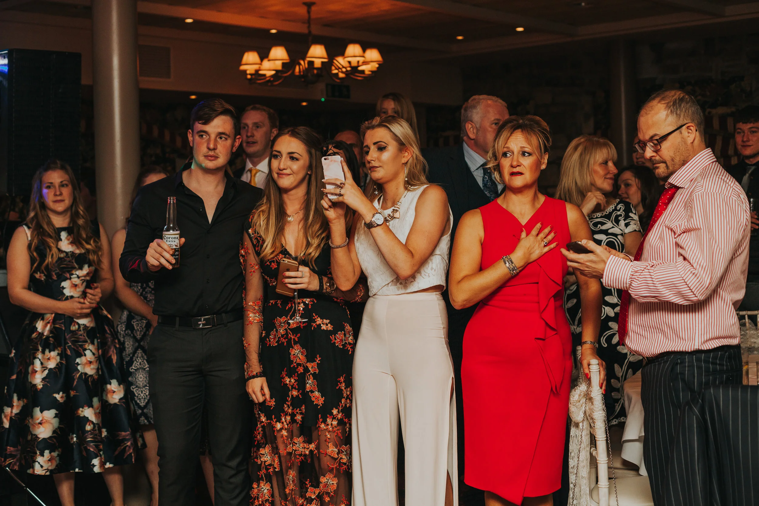 Wedding guests watch the dance getting emotional. 