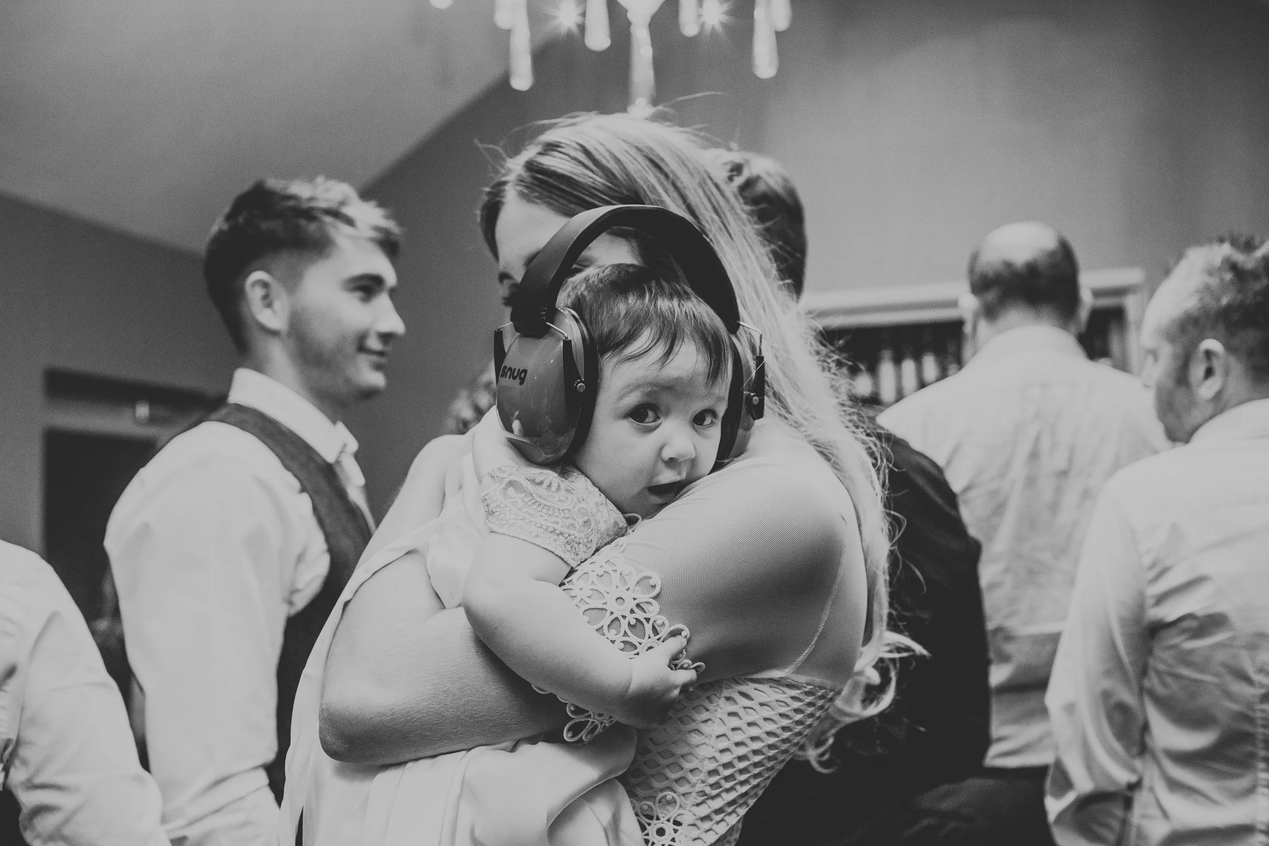 Cute baby with noise cancelling head phones on. 