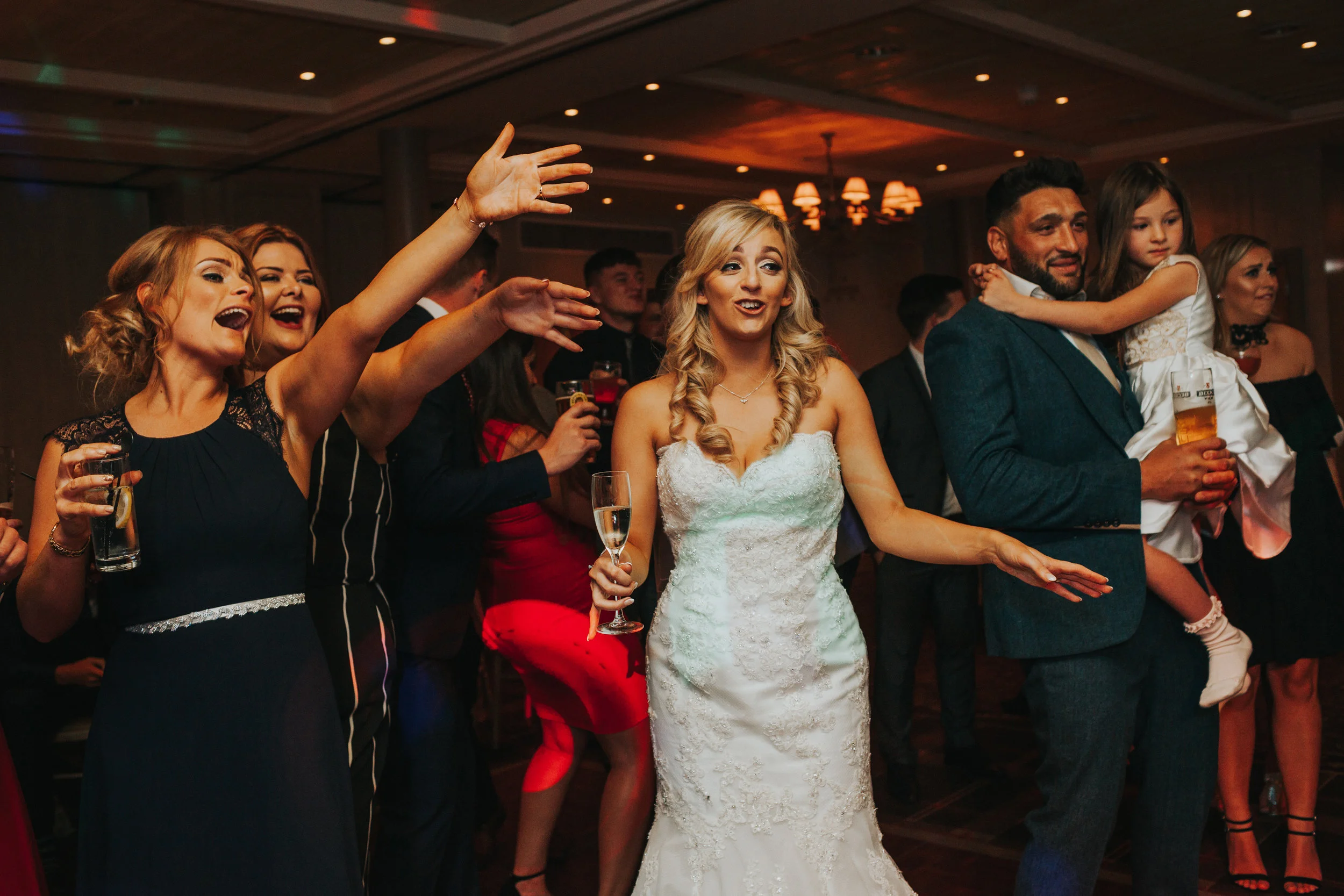 Bride dancing with guests. 