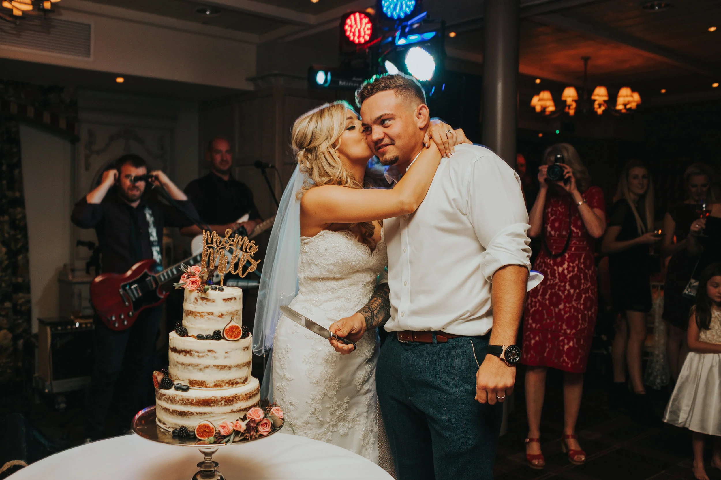 Bride kisses groom.