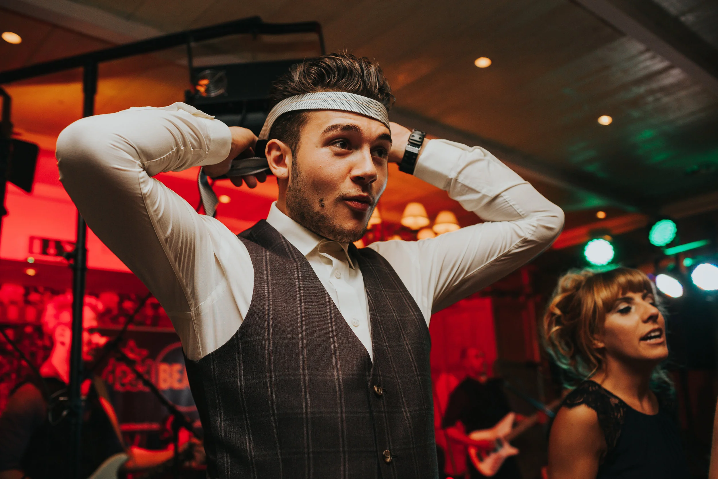 Guest ties his tie around his head. 