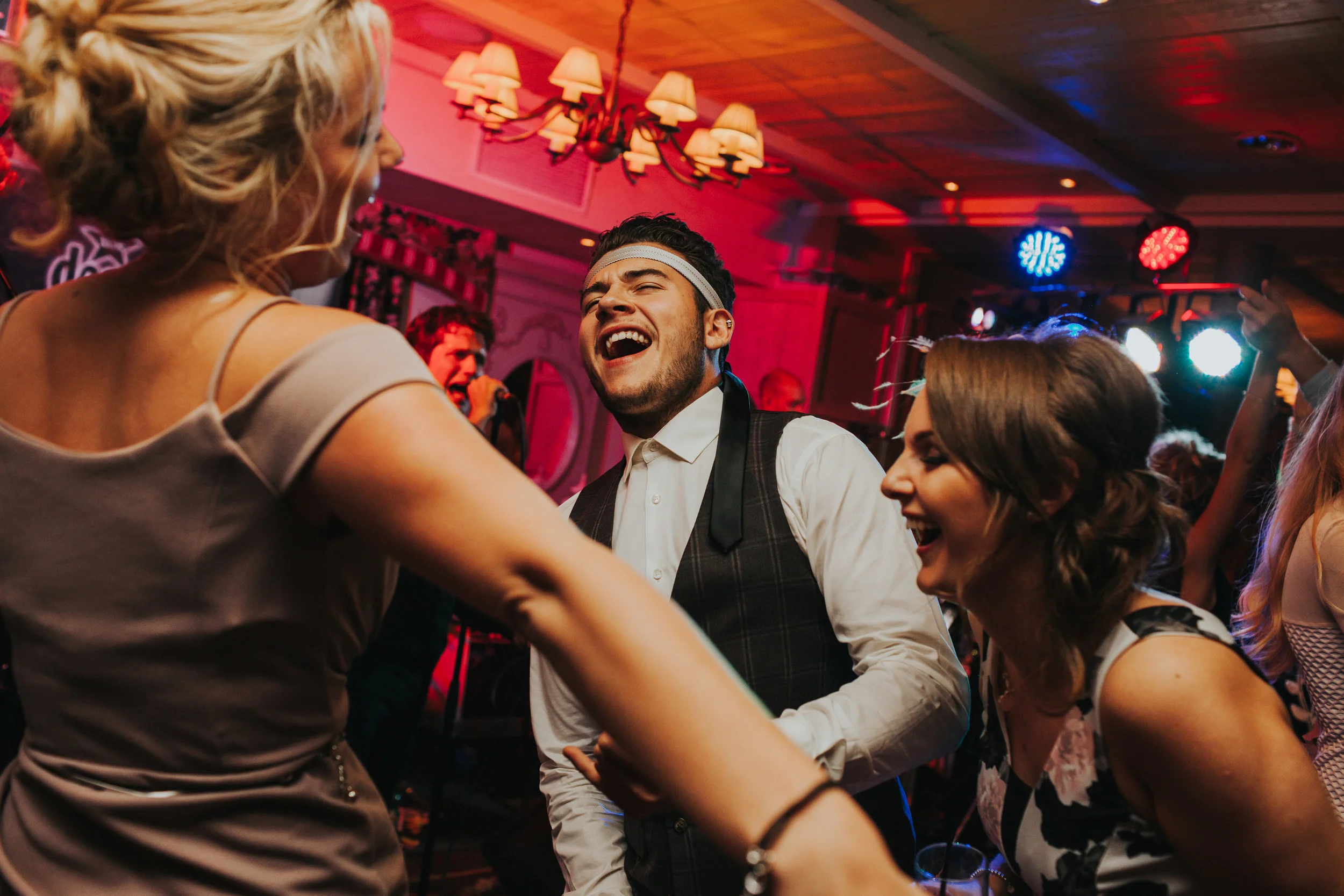 Guest with tie around his head dancing. 