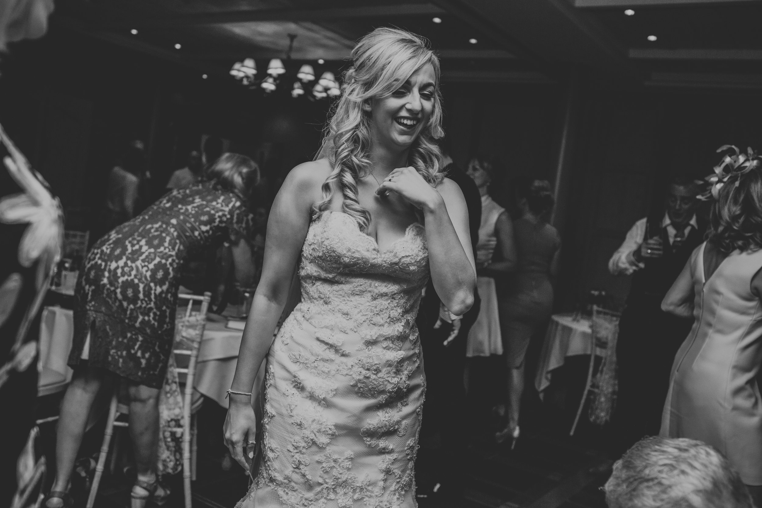Bride laughing on dance floor. 