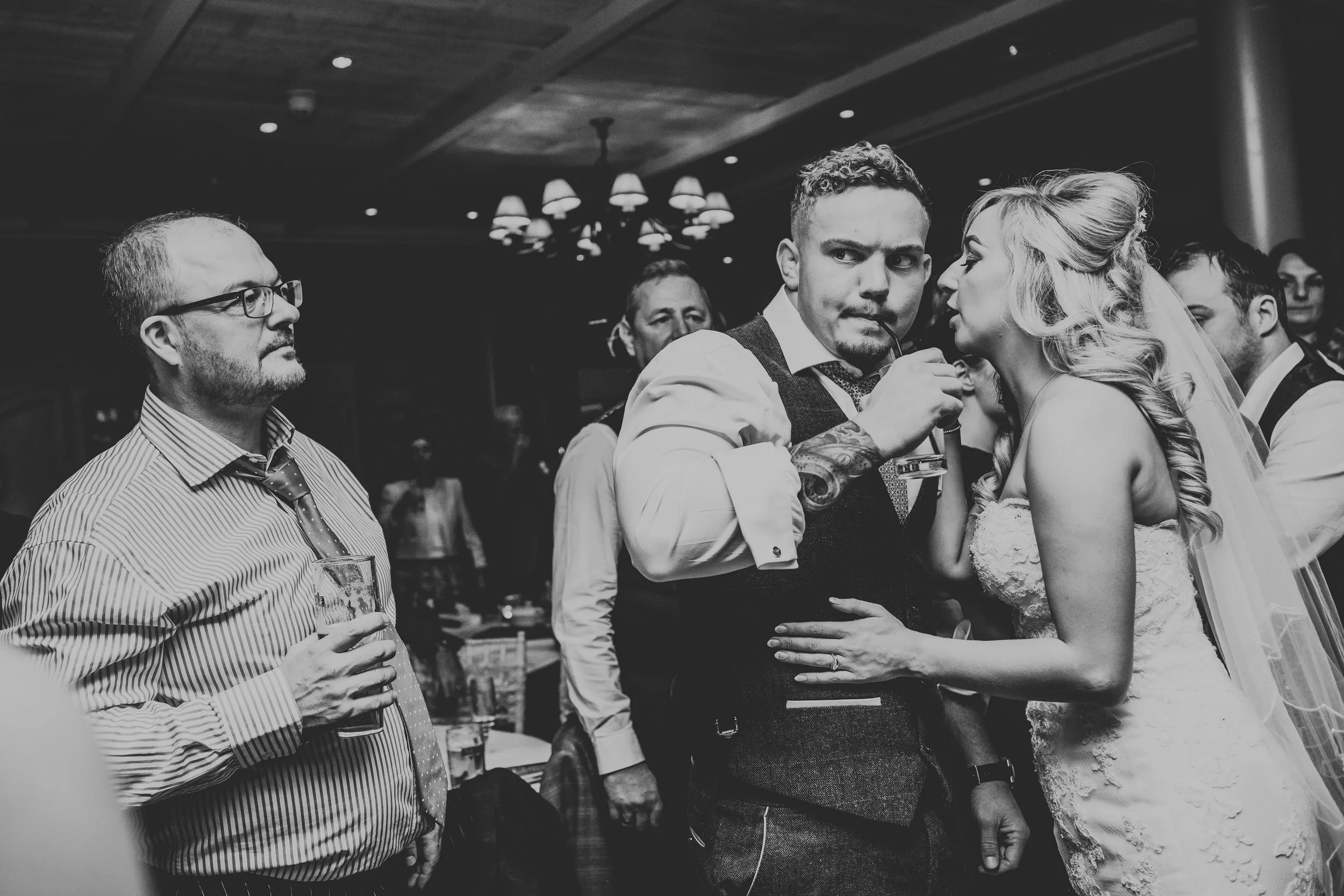 Groom looks quizzical on dance floor. 