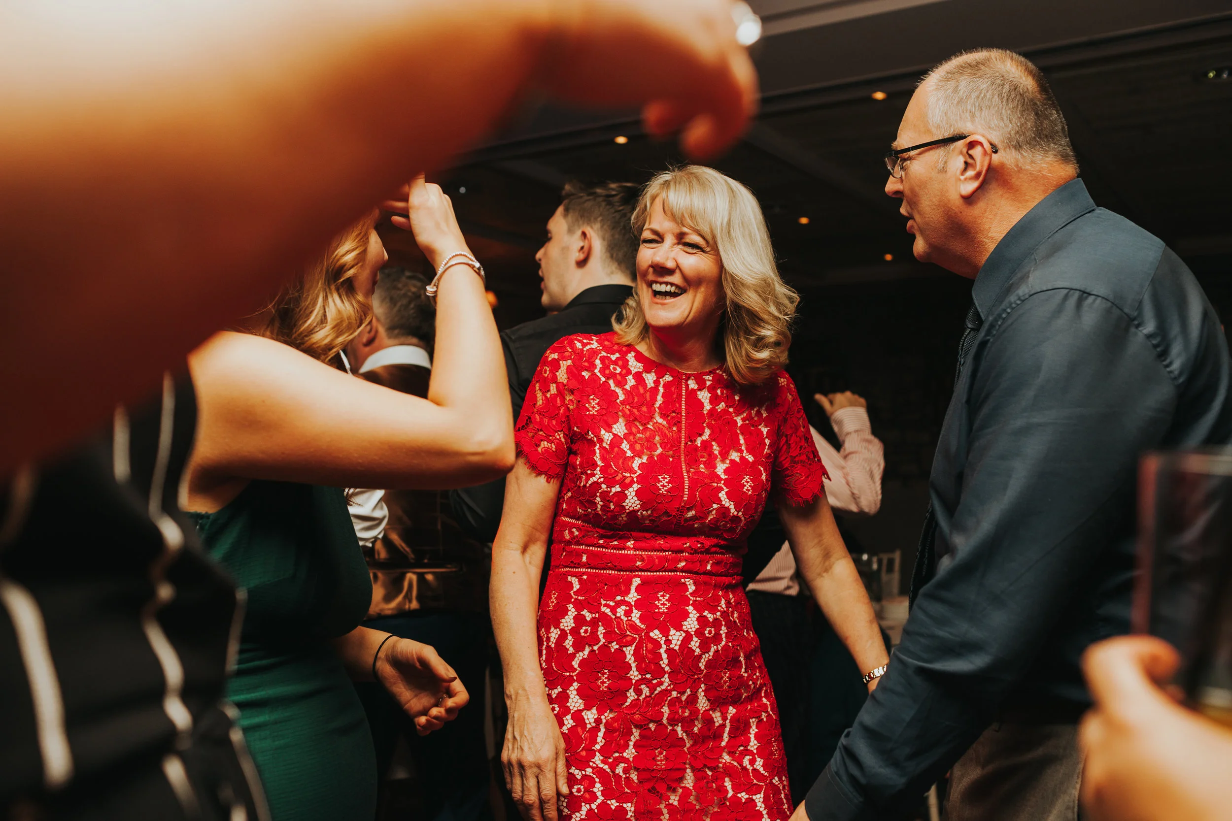 Guests dancing together laughing. 
