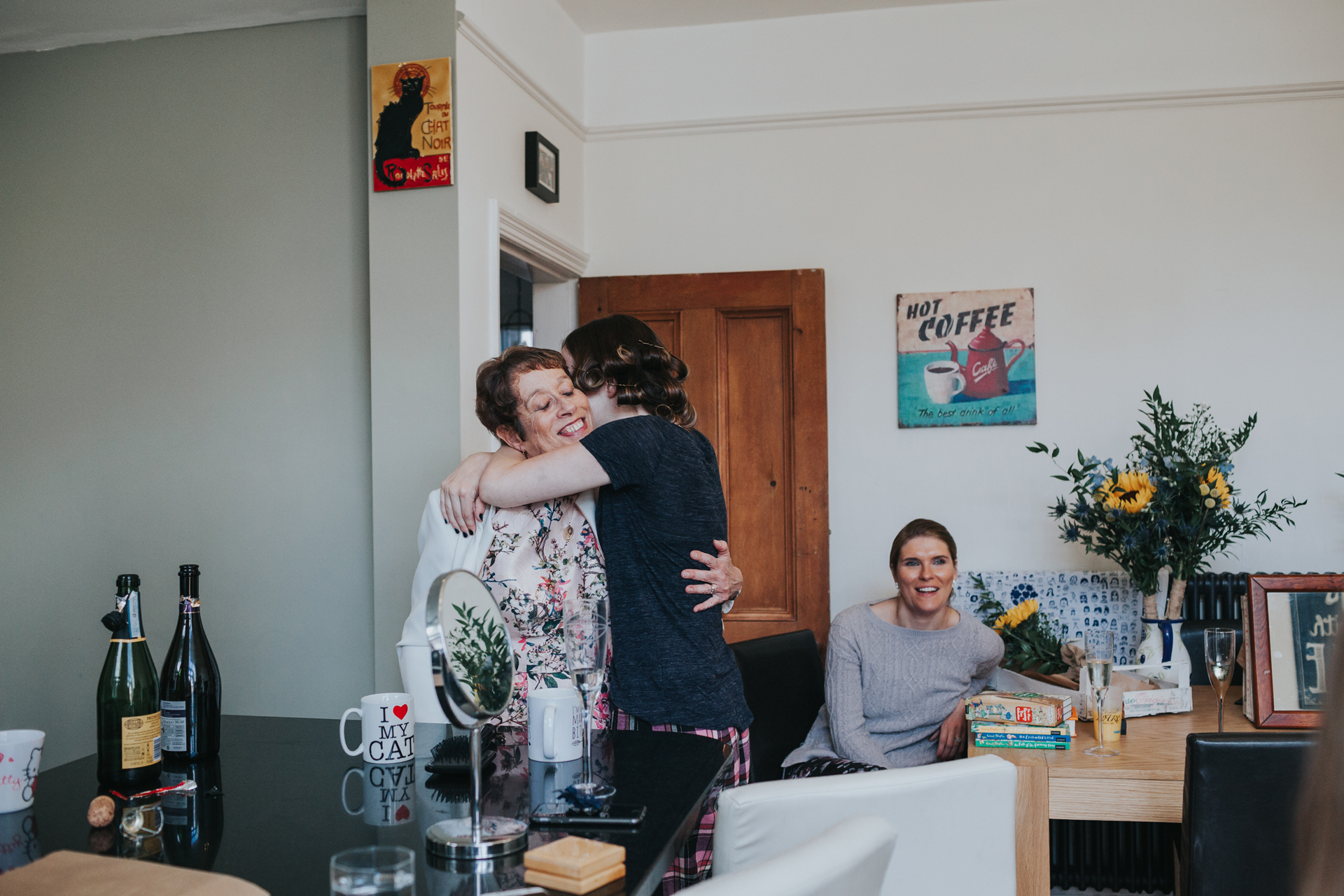 Mum and Bride have a hug in the kitchen on the morning of her wedding day. 