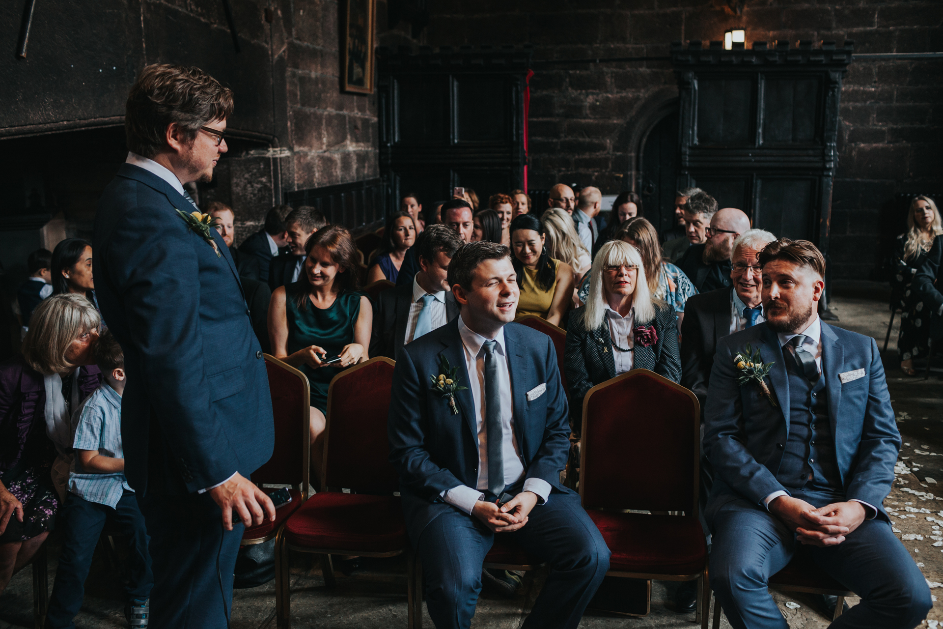 Groomsmen laugh together waiting for the Bride to arrive.