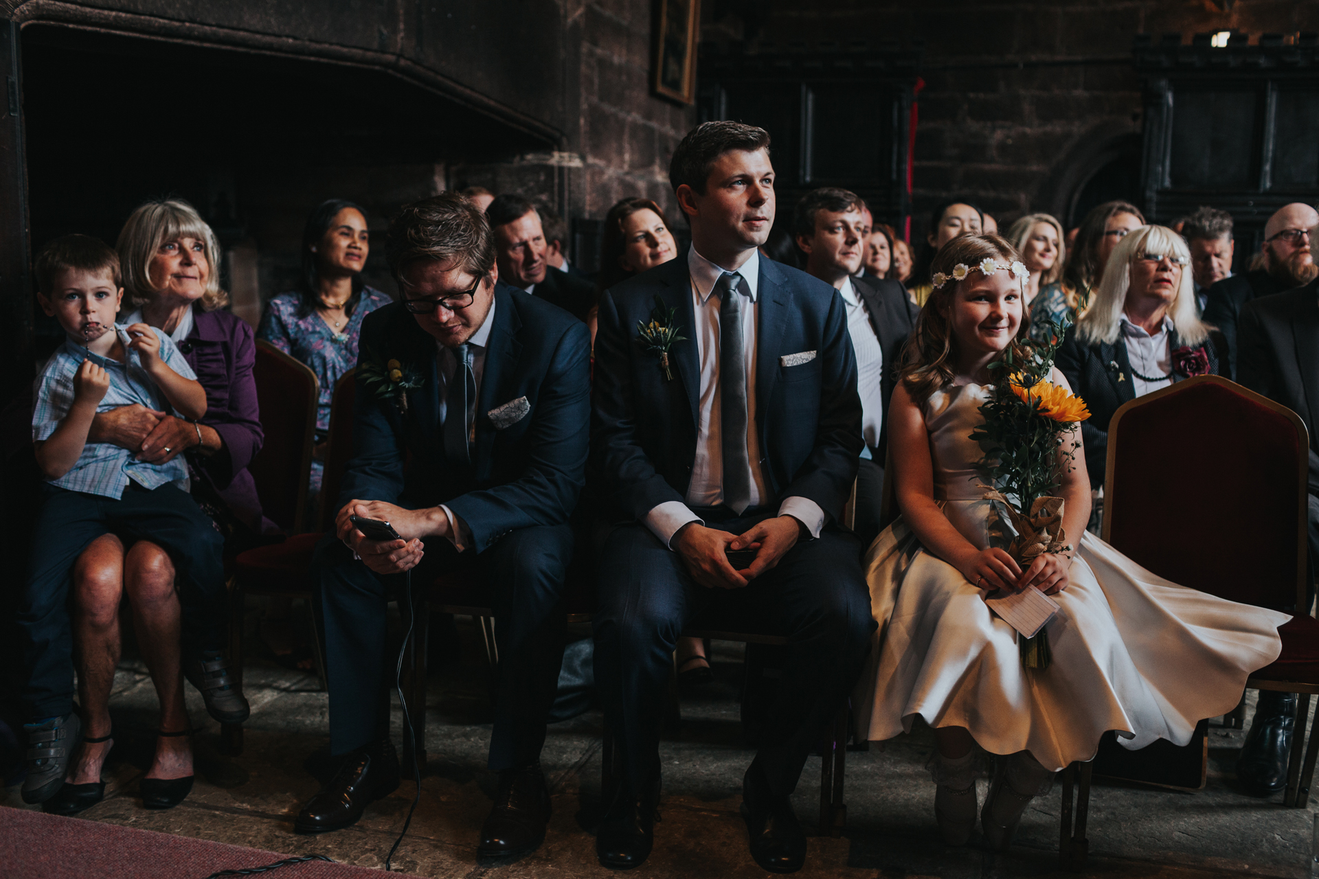Bridesmaid sits with groomsmen looking very excited!