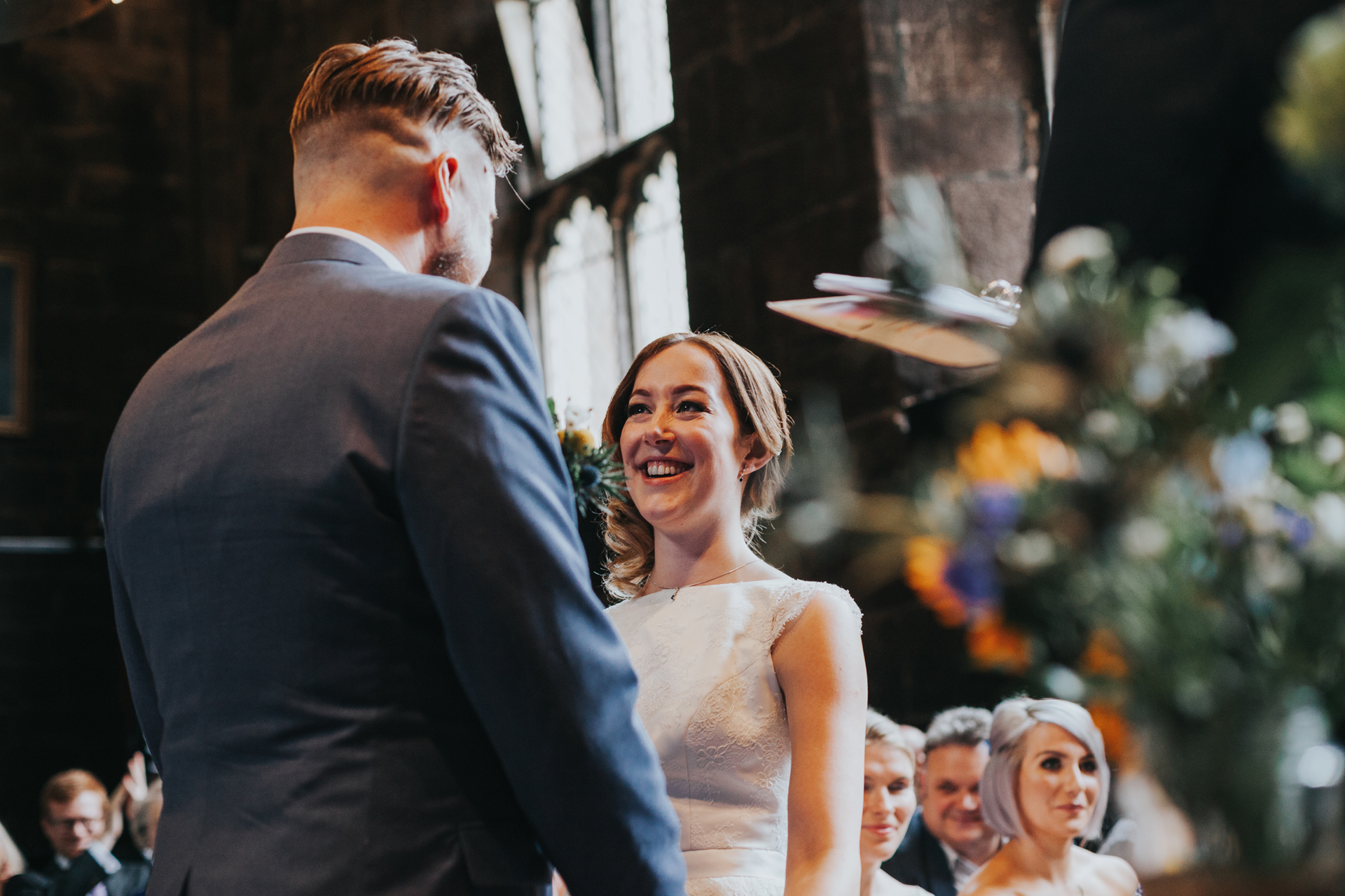 Bride looks at Groom, looking very happy at Chetham's Library Manchester