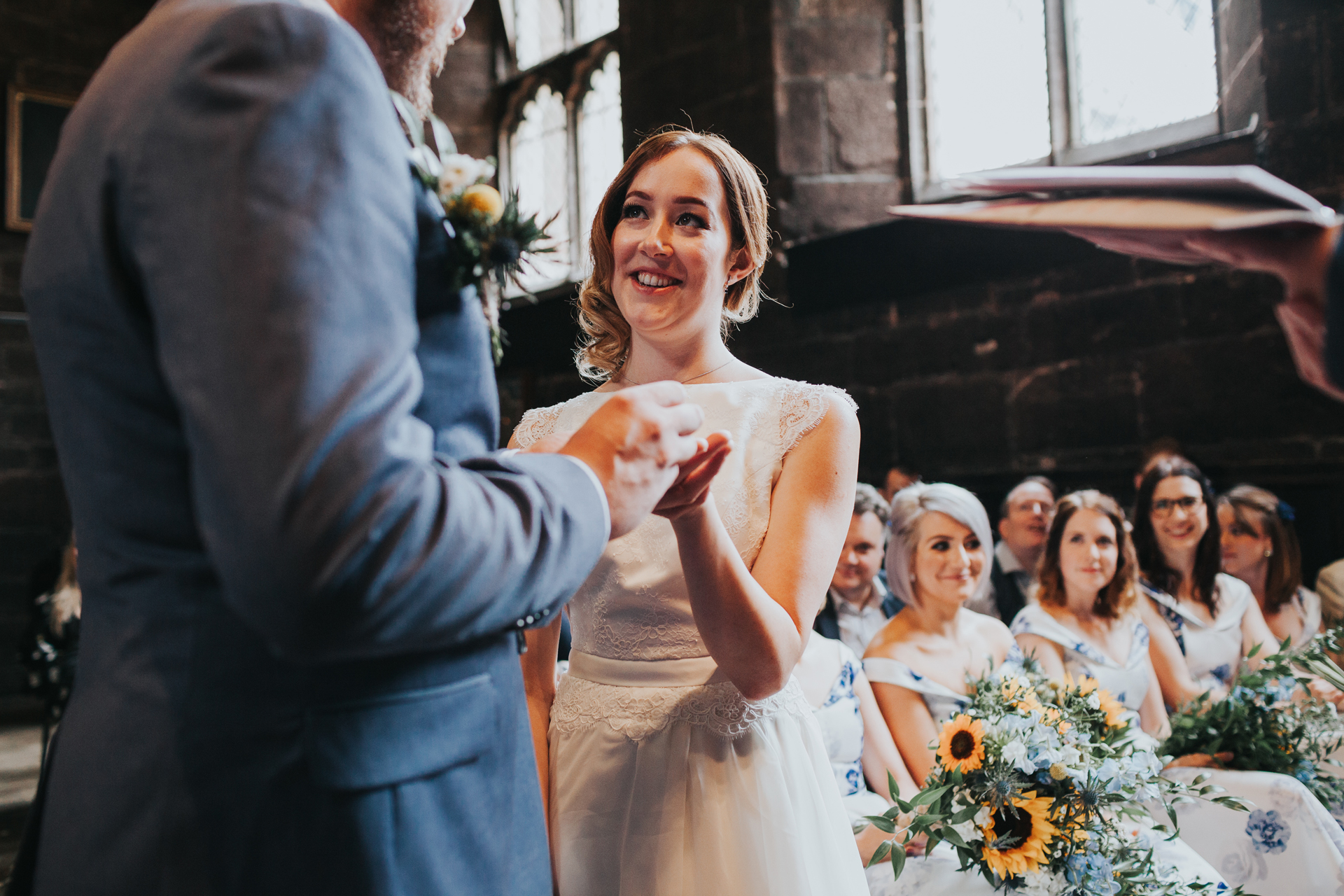 Bride takes her ring at Chetham Library Manchester. 