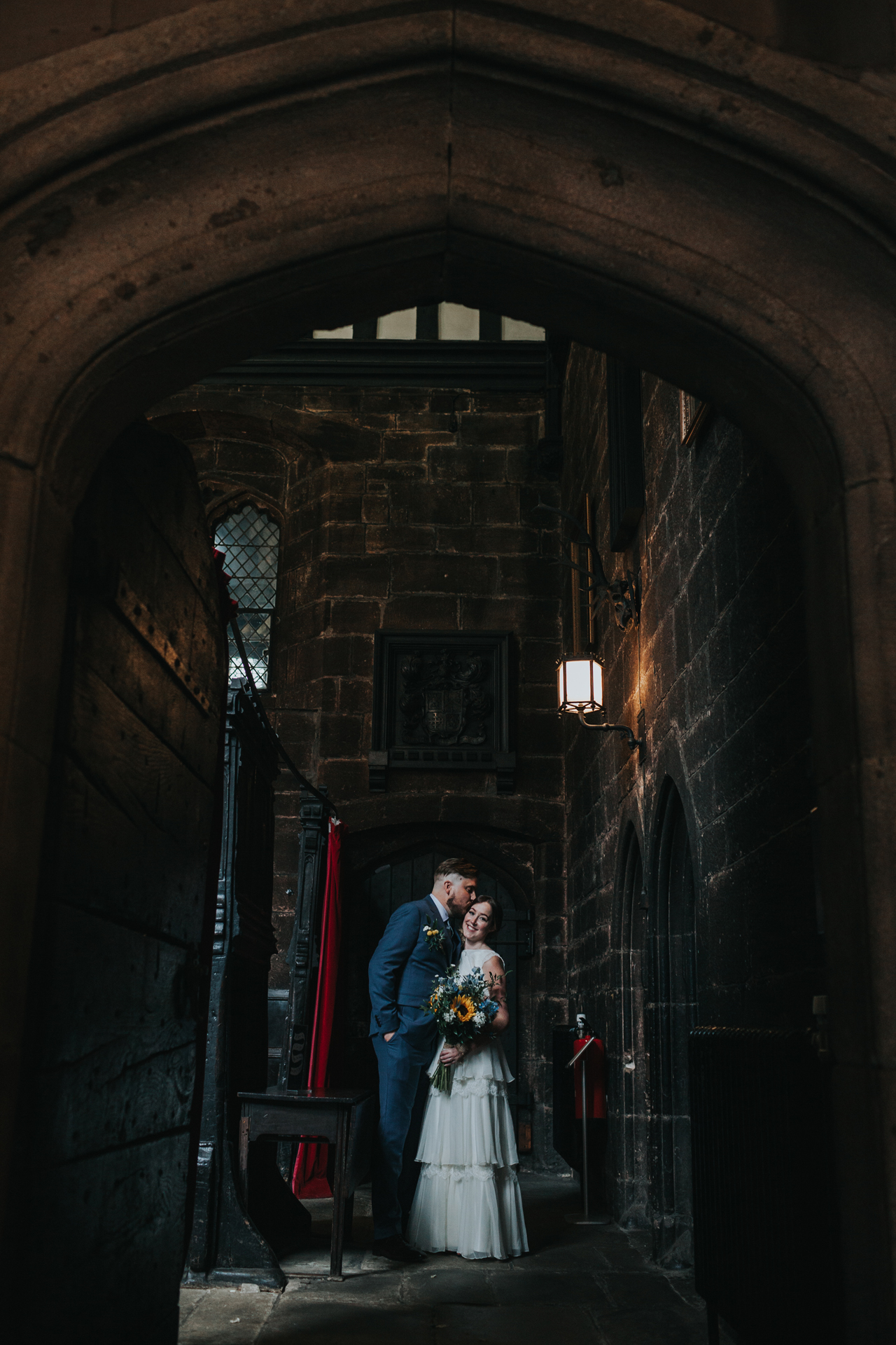 Bride and Groom have a moment in the doorway at Chetham Library Manchester. 
