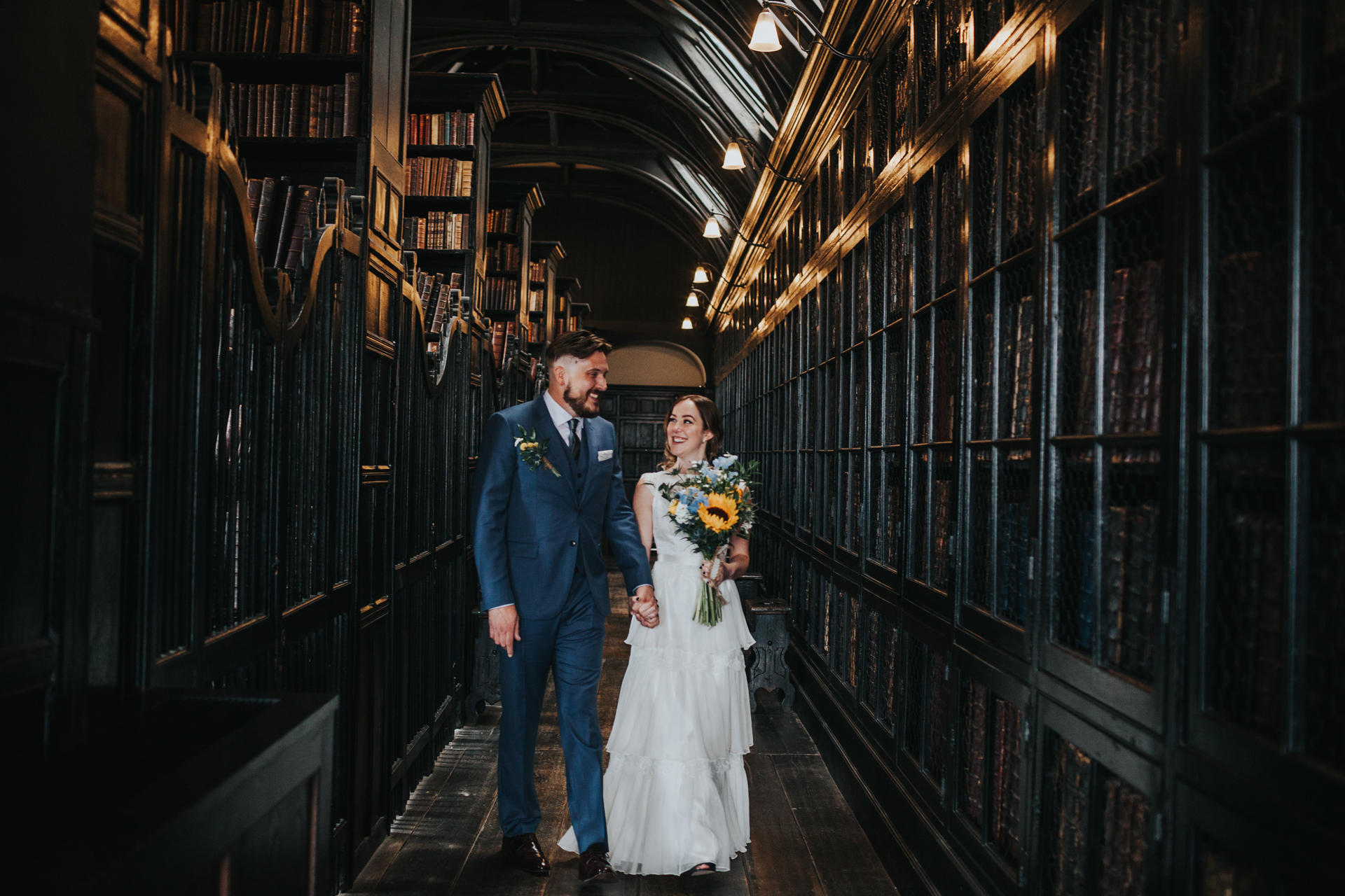 Bride and Groom walk through Chetham Library together.