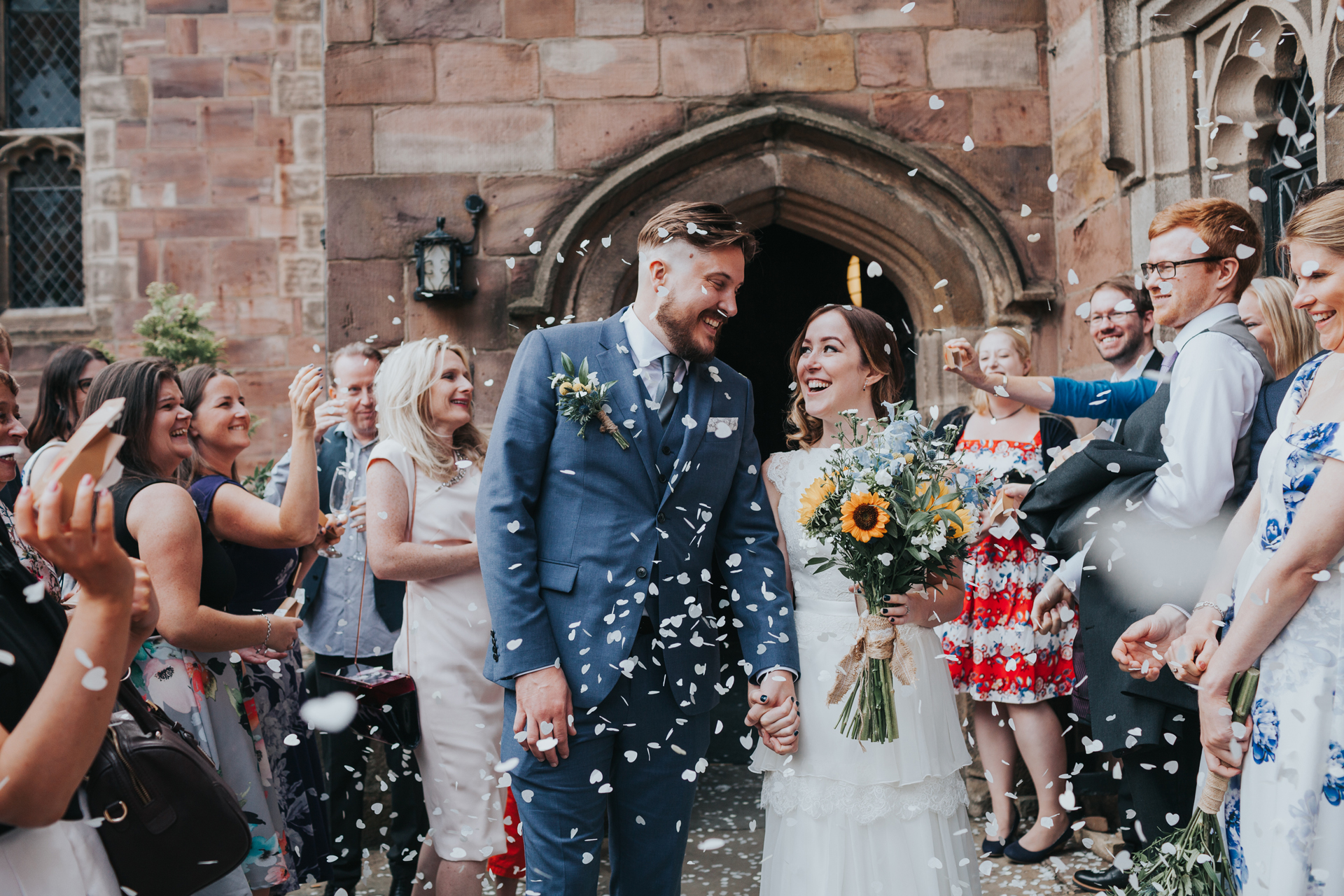 Bride and Groom look at one and other outside Chetham's Library.