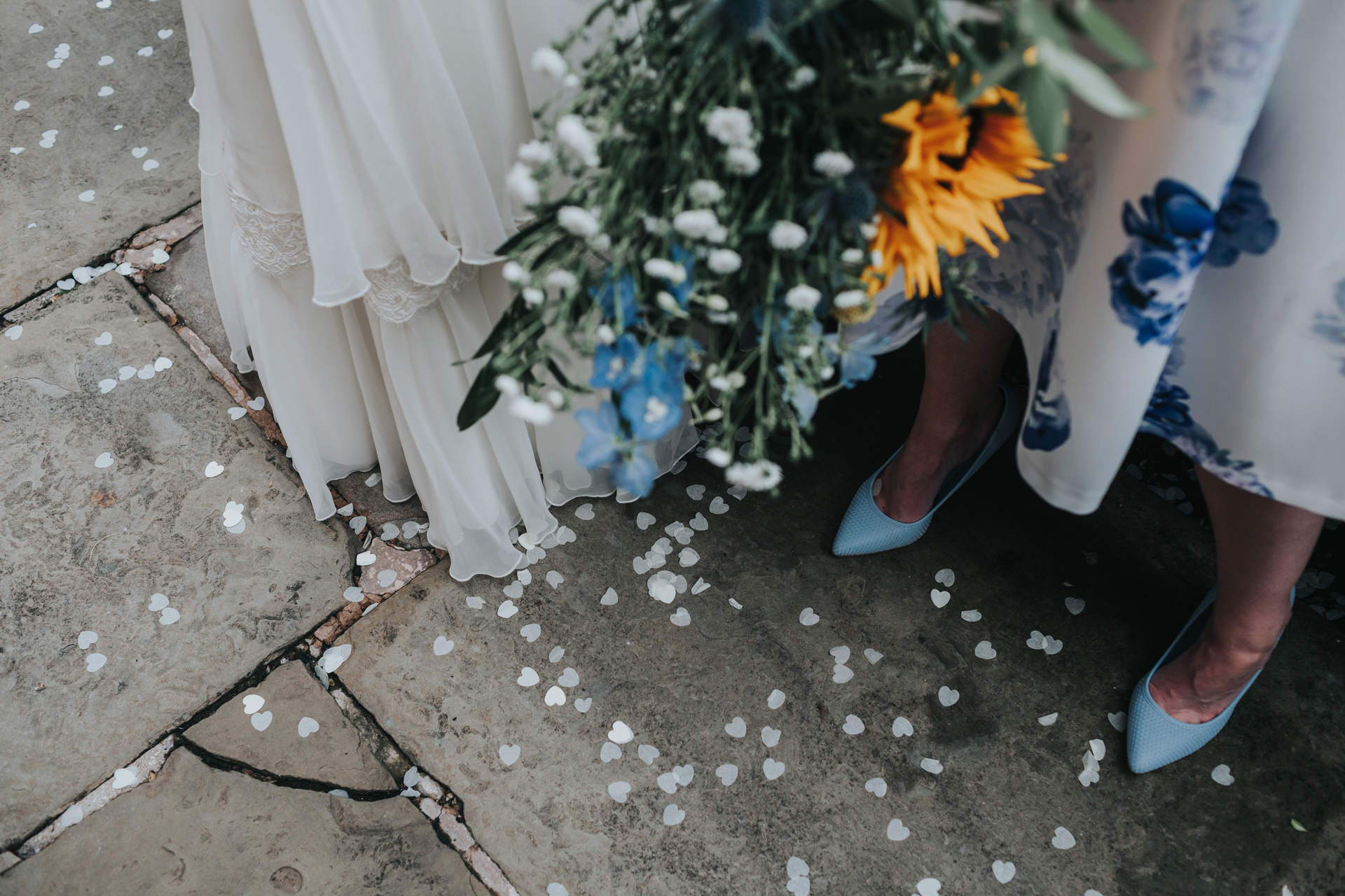 Brides dress, flowers, shoes and confetti. 