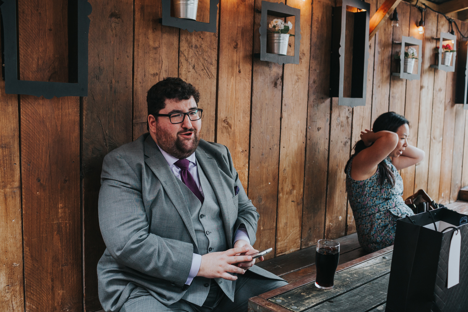 Wedding guest sitting on balcony at Lock 91. 