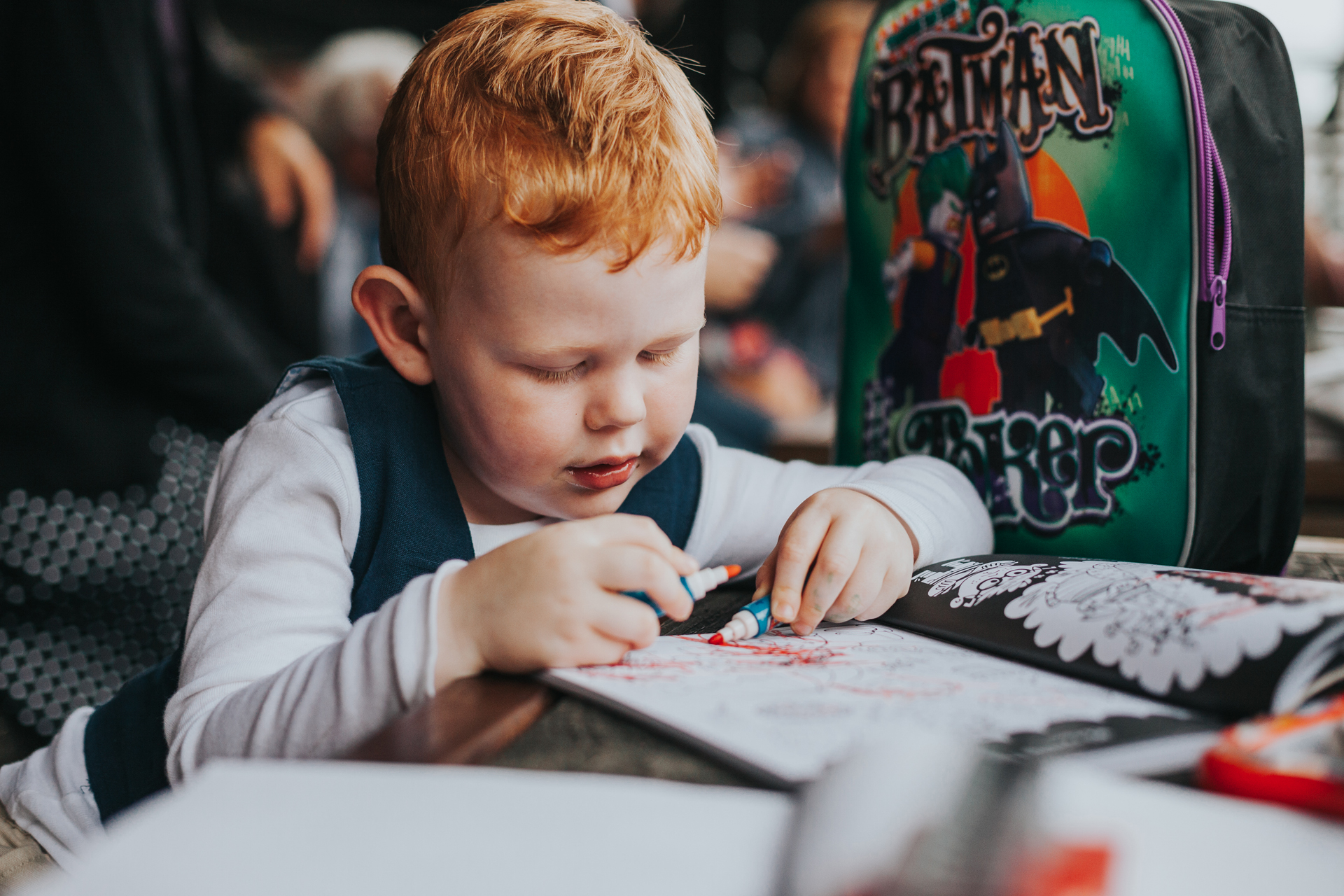 Little boy draws in colouring book at Lock 91 Wedding. 