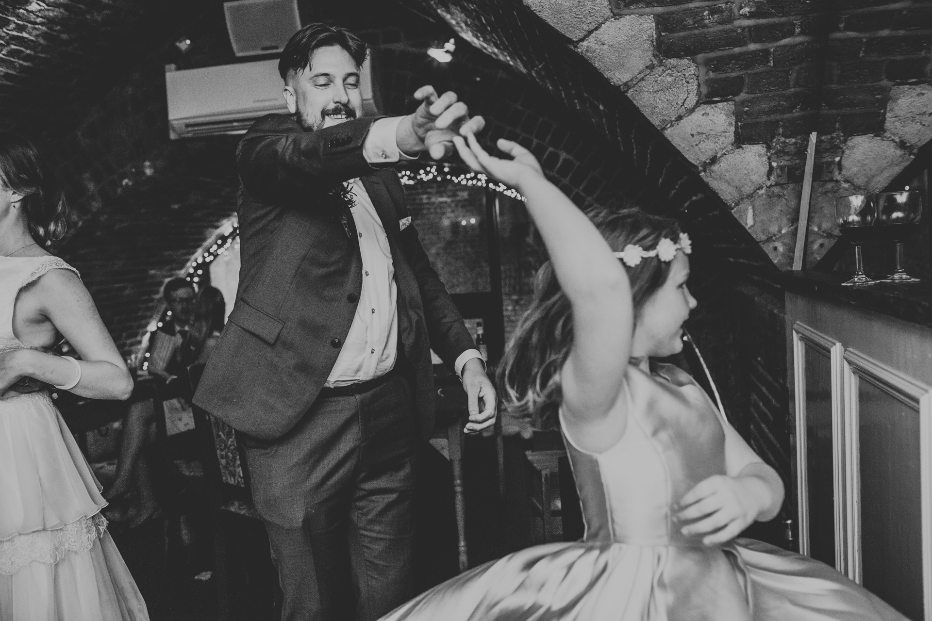 Groom dances with his daughter. 