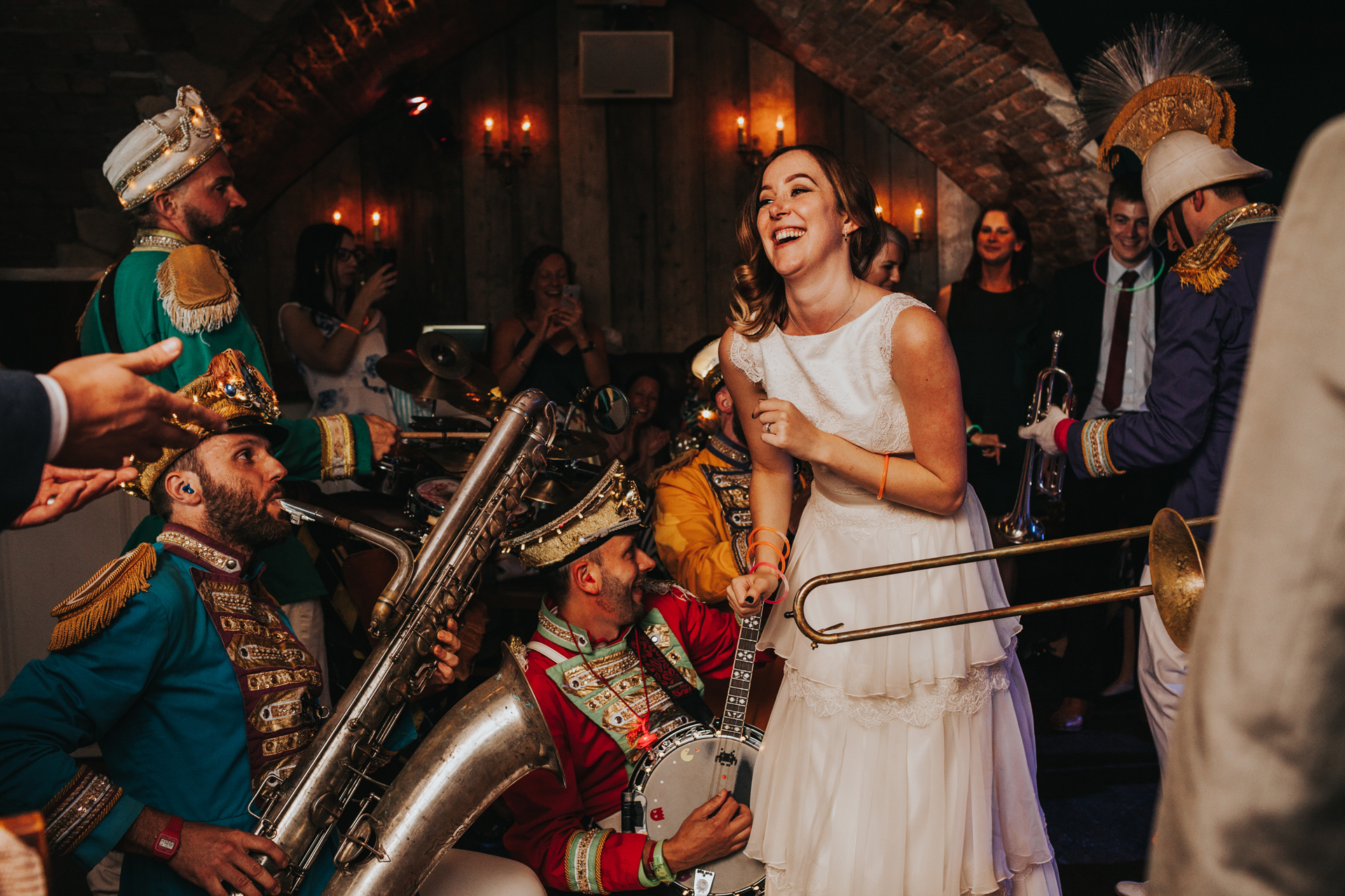 Bride laughs as she is surrounded by Mr Wilson's Second Liners.