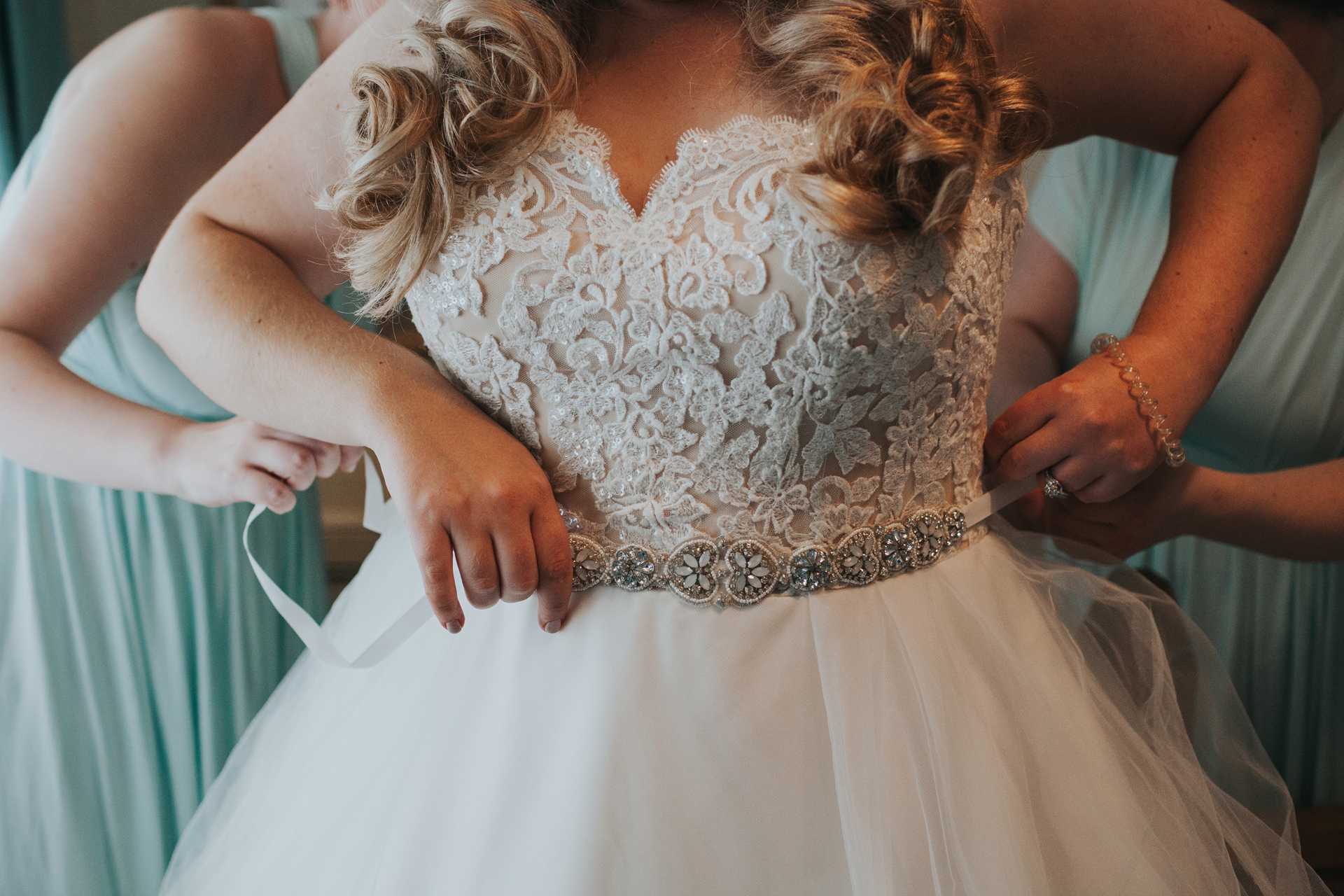 Close up of lace detail on the brides dress. 
